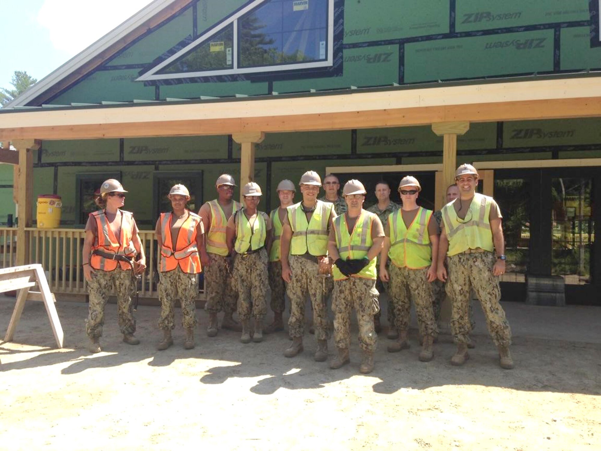 Naval Mobile Construction Battalion 14 Detachment Rotation 5 Seabees stand in front of the Dining Facility they helped to construct as part of a Joint Innovative Readiness Training (IRT) Project at Camp Hinds, Maine. Cmdr. David Wilhite of the U.S. Navy Reserve, commander of the NMCB 14, attended a Distinguished Visitor Day at the camp in support of the project. Wilhite also serves as the Simplified Acquisition of Base Engineering Requirements program manager at AEDC. (Courtesy photo/David Wilhite)