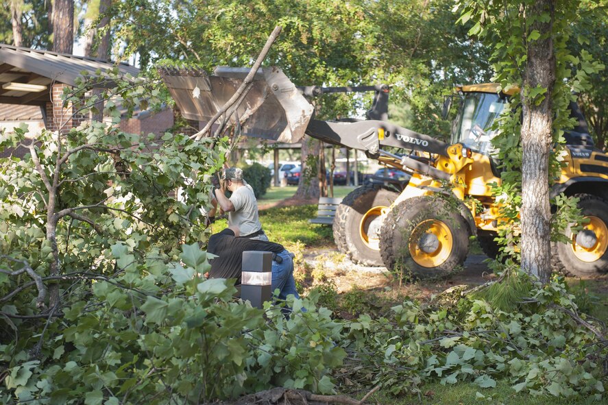 Members of the 23d Civil Engineer Squadron clear debris near Airmen’s dormitories, Sept. 6, 2016, at Moody Air Force Base, Ga. Fallen trees and debris were left behind after Tropical Storm Hermine struck with roughly 70 mph winds and heavy rains. (U.S. Air Force photo by Airman 1st Class Daniel Snider)