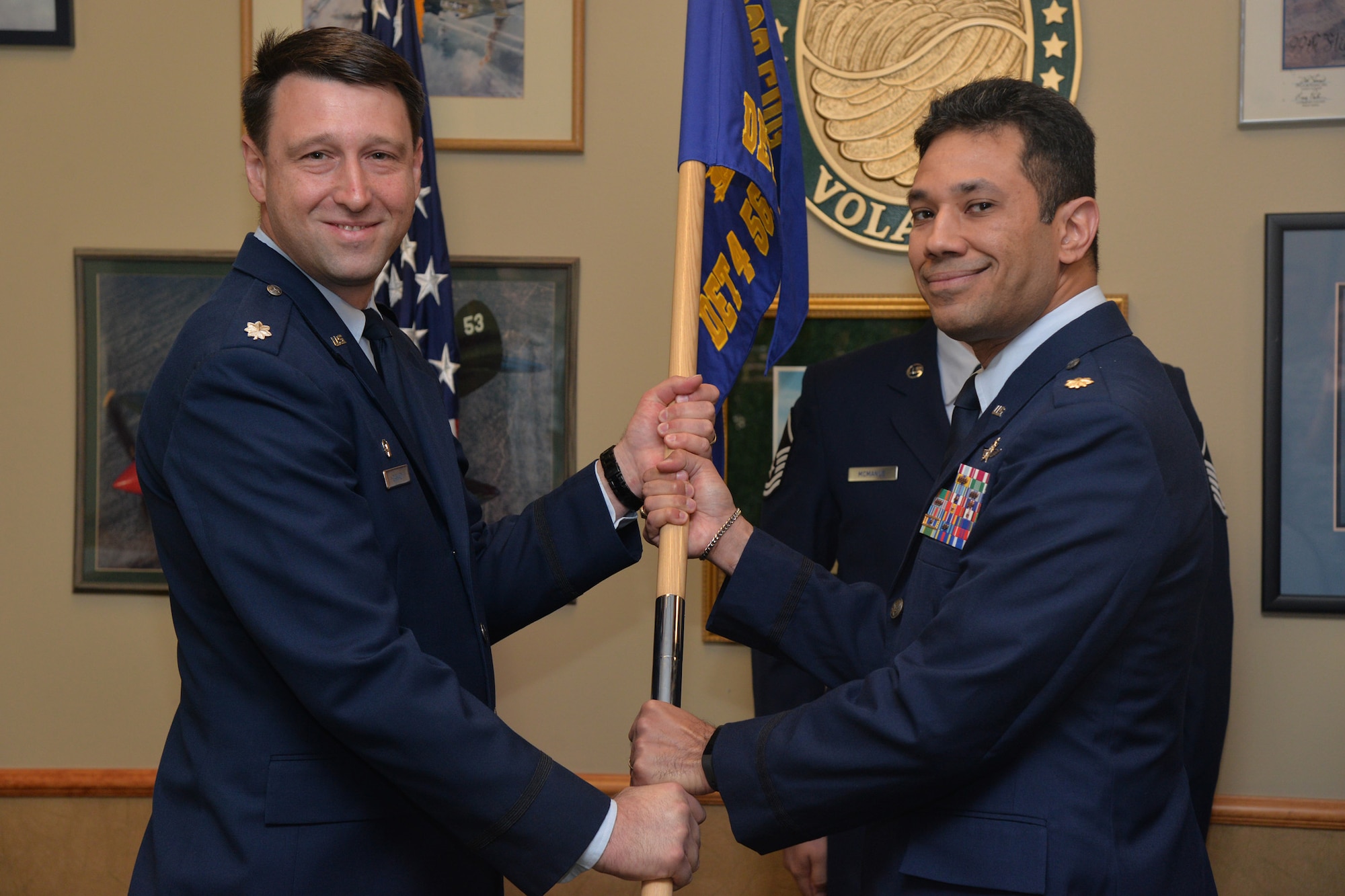 Maj. Luis Morales, right, accepts command of the 561st Network Operations Squadron Detachment 4 from Lt. Col. David Canady, 561st NOS commander, during a change of command ceremony at the Malmstrom Air Force Base Grizzly Bend Sept. 6. Master Sgt. Chad McManus, 561st NOS cyber operations flight chief, looks on. (U.S. Air Force photo/Airman 1st Class Daniel Brosam)