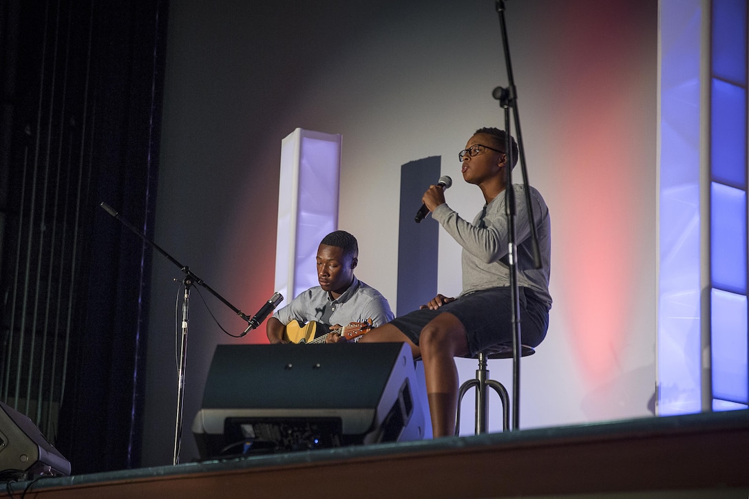 Lance Cpl. Caleb Batiste and Pfc. Taylor Miller, students, Marine Corps Communication-Electronics School, perform during the Single Marines Program’s 7th Annual Marines Got Talent Show at the Sunset Cinema, Aug. 12, 2016. The event is held to give service members the opportunity to show their talent with the rest of the Combat Center community. (Official Marine Corps photo by Cpl. Thomas Mudd/Released)
