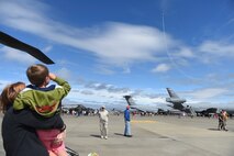 A young child and his mother watch an aircraft performance during the Joint Base Lewis-McChord Airshow and Warrior Expo Aug. 28, 2016, at JBLM, Wash. More than a dozen aircraft performed during the air show for guests. There were also more than two dozen static aircraft displays for the community to tour during the air show to gain firsthand experience of the various aircraft.(U.S. Air Force photo/Staff Sgt. Naomi Shipley)