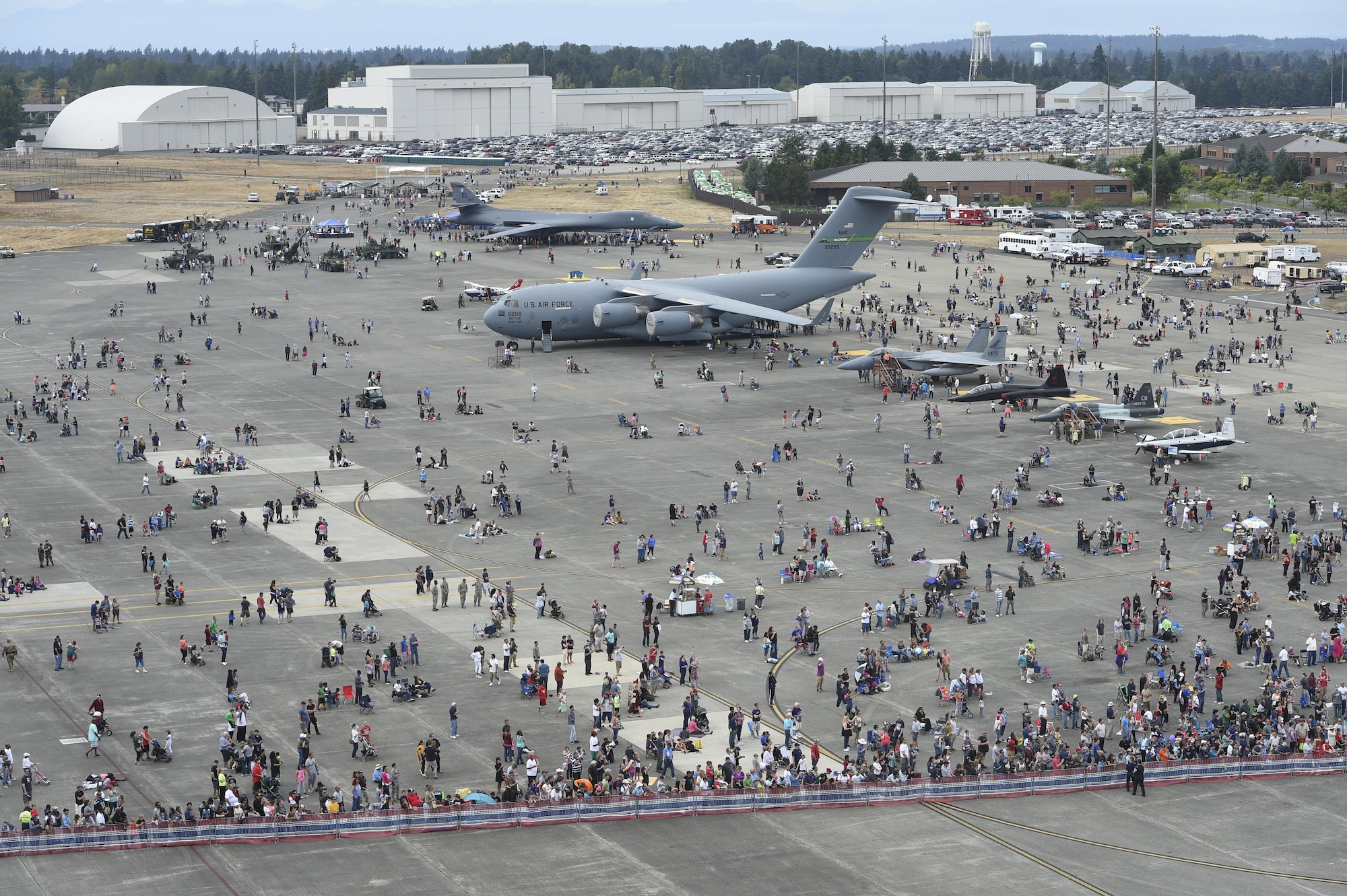 Thousands of people walk around during the Joint Base Lewis-McChord Airshow and Warrior Expo Aug. 27, 2016, at JBLM, Washington. The community was able to visit various static air craft displays, talk to Soldiers and Airmen and also experience several hours of air show performances. (U.S. Air Force photo/Staff Sgt. Naomi Shipley)