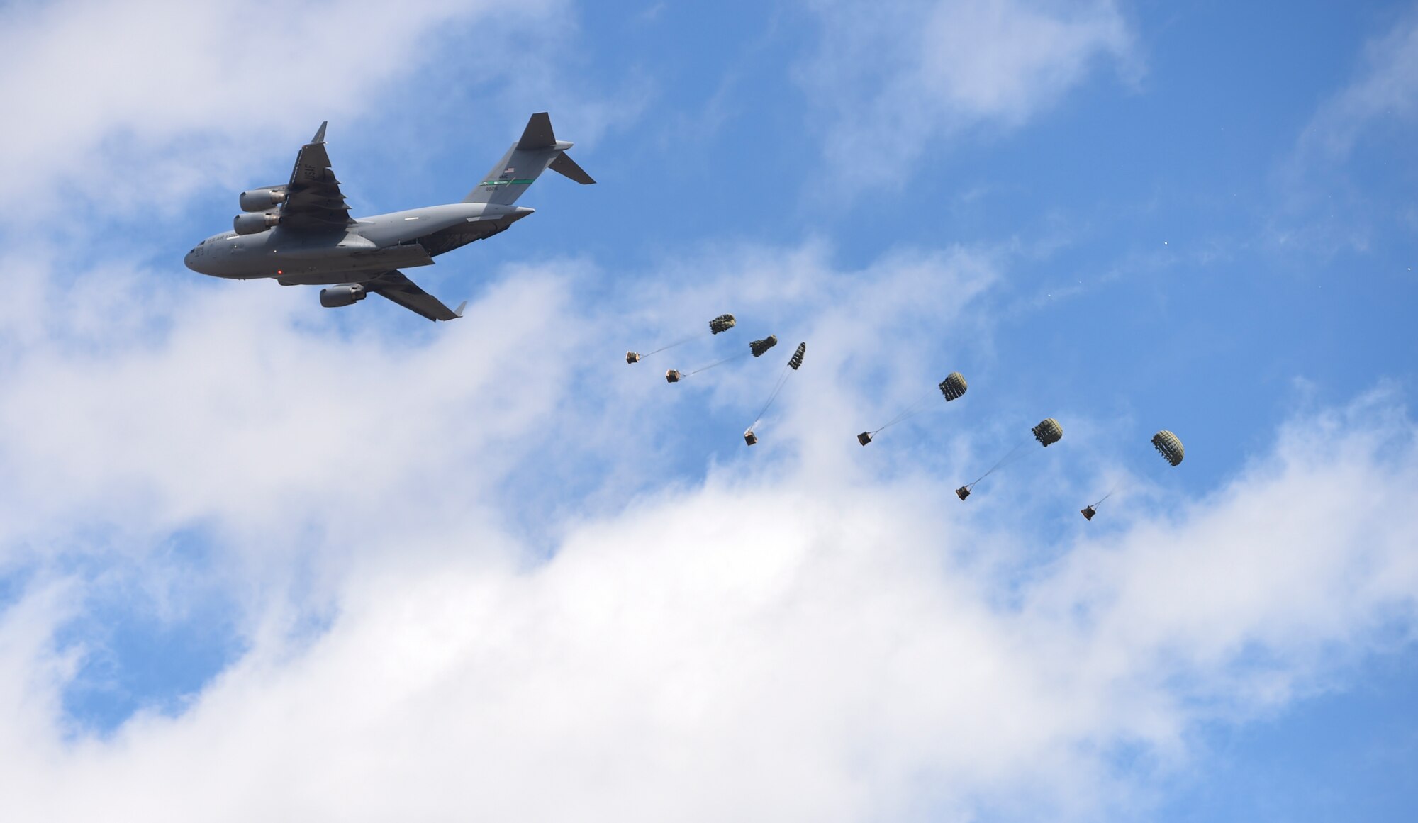 A McChord C-17 Globemaster III conducts an air drop during the Joint Base Lewis-McChord Airshow and Warrior Expo Aug. 27, 2016, at JBLM, Wash.  The C-17 demonstrated its capabilities for the crowd during both days of the air show along with countless other air craft performers. (U.S. Air Force photo/Staff Sgt. Naomi Shipley)