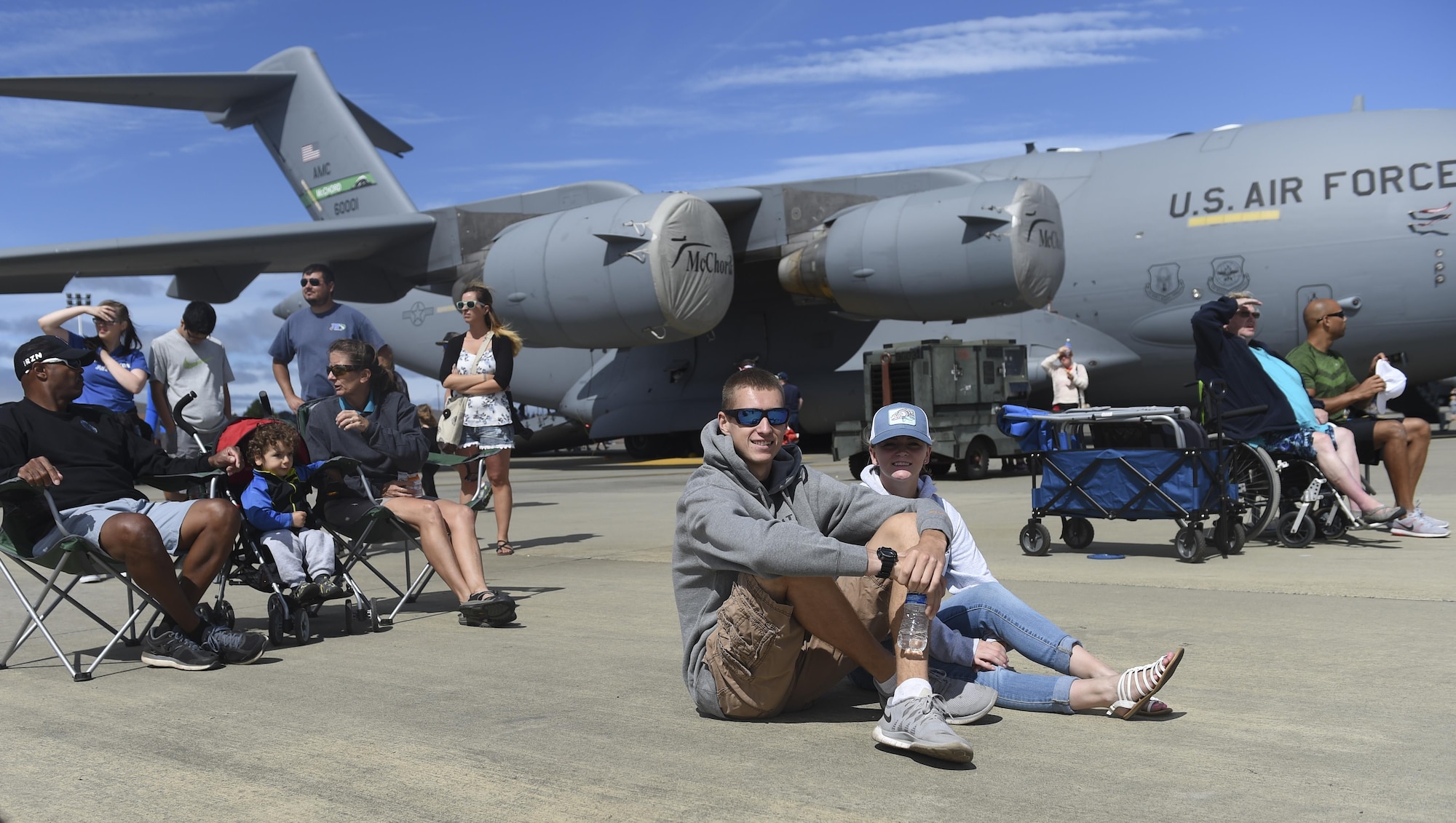 Guests sit and watch air craft performances during the Joint Base Lewis-McChord Airshow and Warrior Expo Aug. 28, 2016, at JBLM, Wash. Thousands watched the air performances during the two-day event, which included more a dozen air show performances. (U.S. Air Force photo/Staff Sgt. Naomi Shipley)