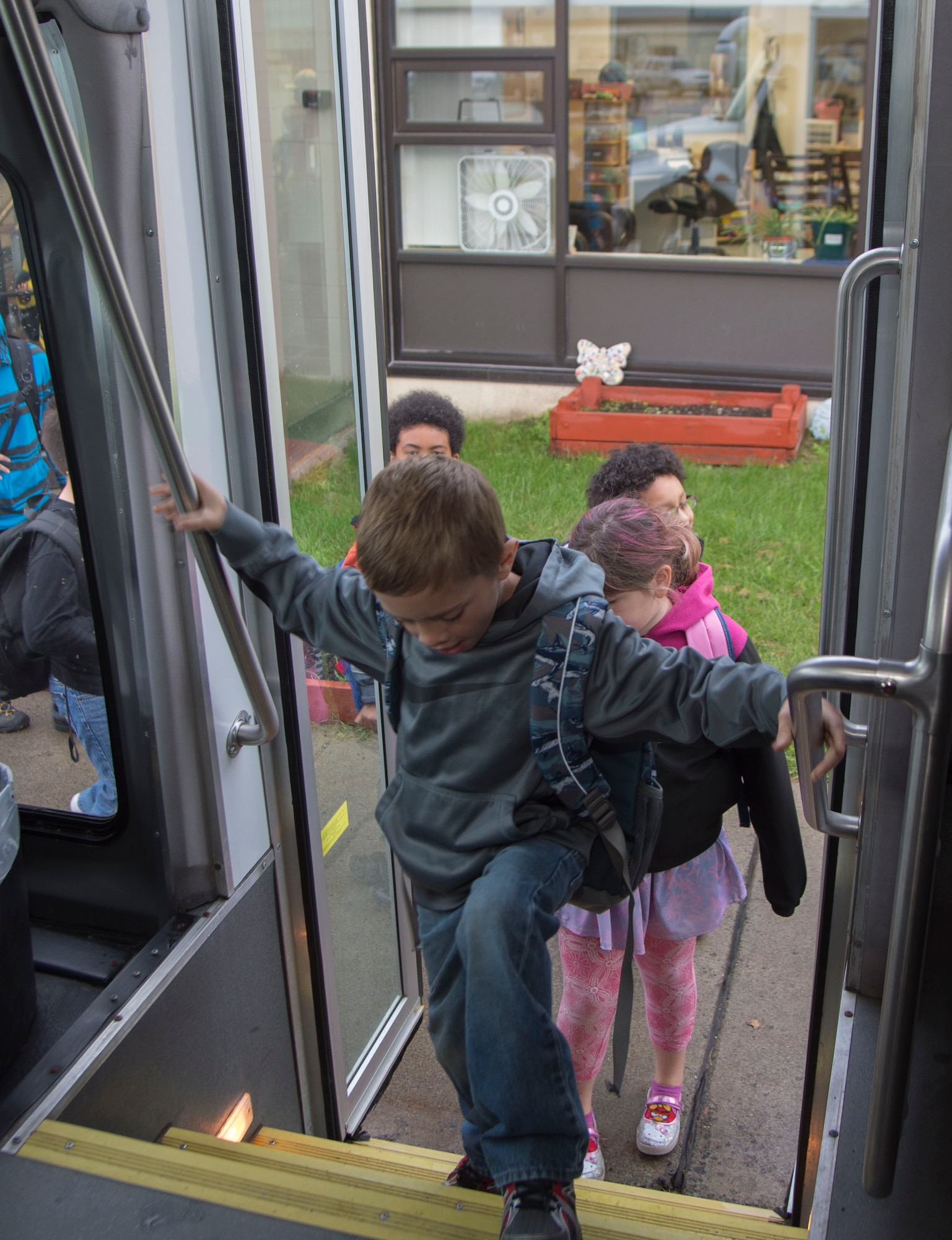 Ketchikan School Age Center students get on the bus on their way to school after being dropped off at the before-and-after school care programs for school-age children at Joint Elmendorf-Richardson, Alaska, Sept. 6, 2016. Ketchikan School Age Center roughly bused 150 students to and from school and provide before-and-after school care program for school-age children. (U.S. Air Force photo by Staff Sgt. Sheila deVera)
