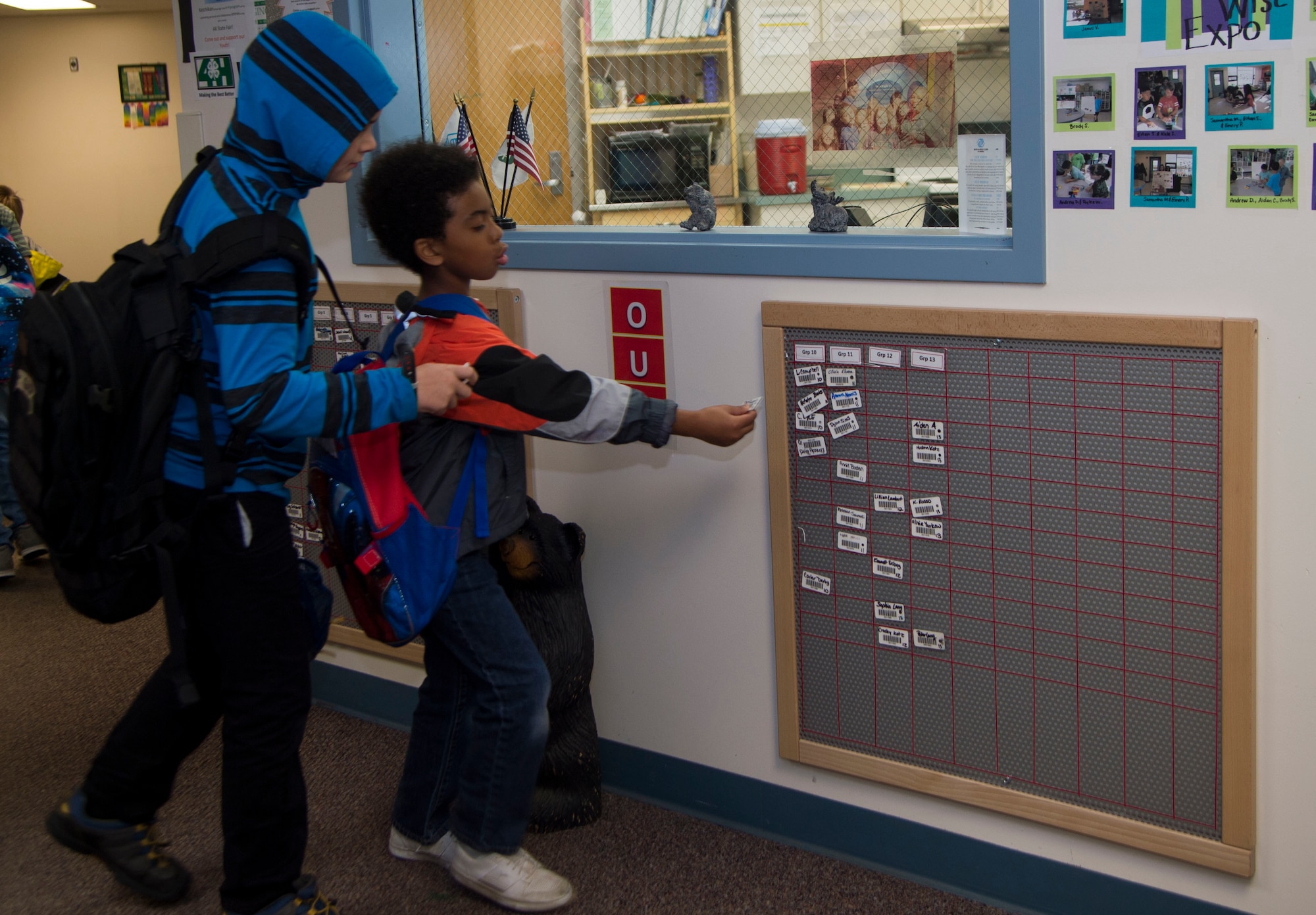 Joshua Gaspard (left to right), 9, and Devin Hogan, 7, sign their name on the board on their way to school from Ketchikan School Age Centers at Joint Base Elmendorf-Richardson, Alaska, Sept. 6, 2016. Ketchikan School Age Center offers a wide range of activities including computer lab, arts programs and field trips. (U.S. Air Force photo by Staff Sgt. Sheila deVera)