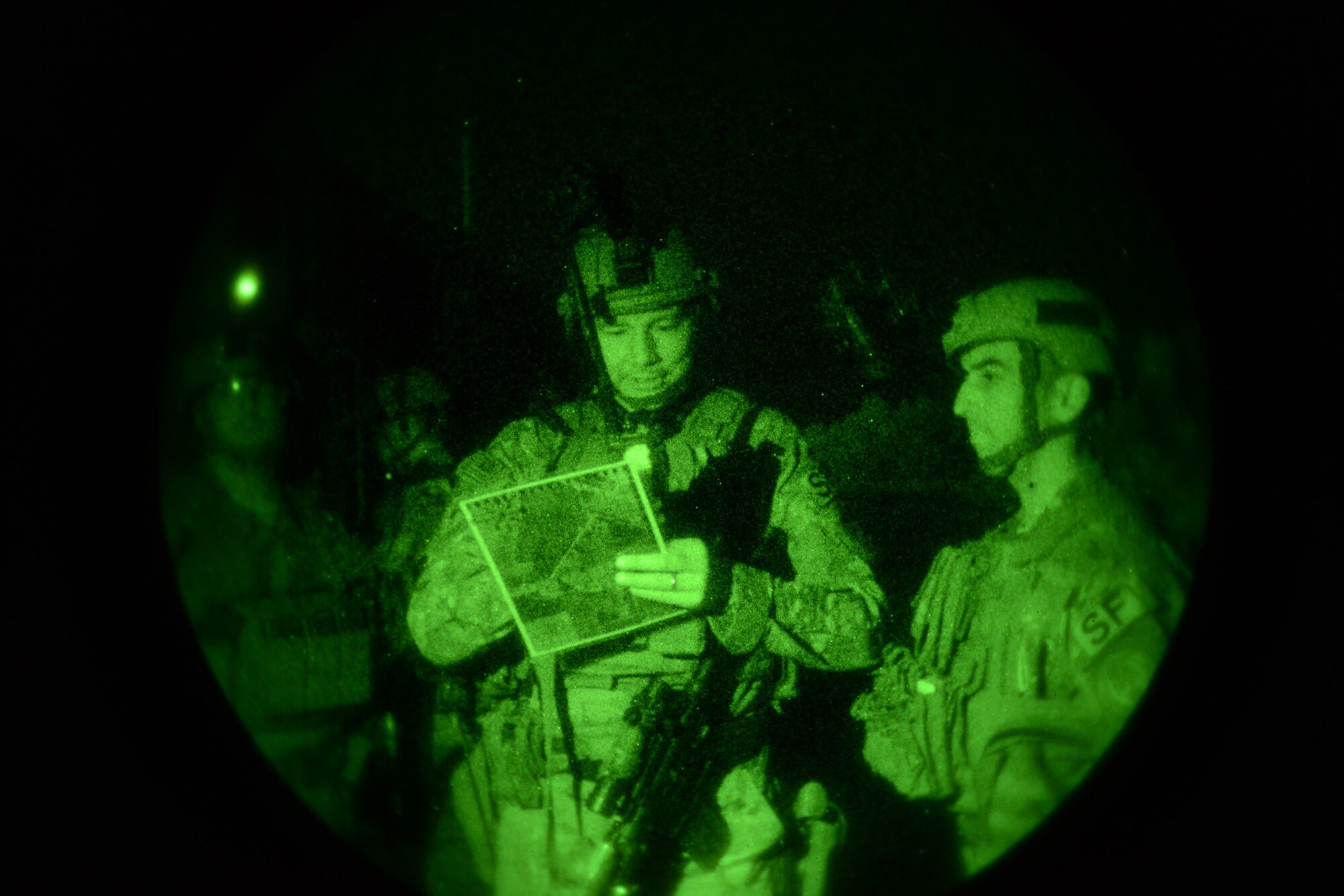 Airmen from the 741st Missile Security Forces Squadron practice using a grid reference graphics map during night ground and air integration training Aug. 25, 2016 at Malmstrom Air Force Base, Mont. The six three-man teams accomplished 107 different iterations. (U.S. Air Force photo/Staff Sgt. Delia Marchick)