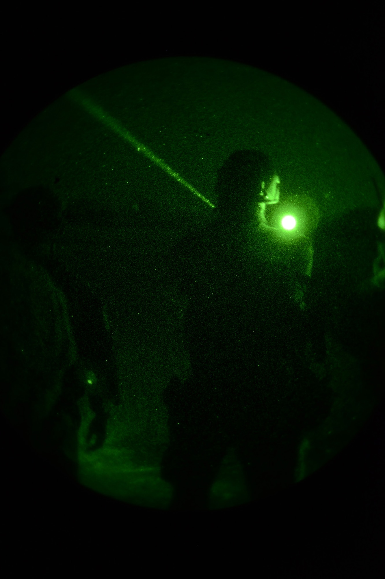 Airmen from the 741st Missile Security Forces Squadron take turns using infrared lasers to signal friendly and enemy locations Aug. 25, 2016 during training at Malmstrom Air Force Base, Mont. The Airmen completed a final full scale field training exercise after learning ground operations and ground/air integrated communication with the 40th Helicopter Squadron. (U.S. Air Force photo/Staff Sgt. Delia Marchick)