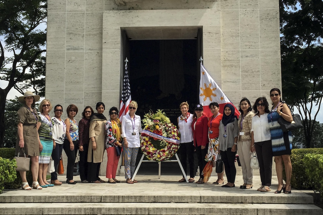 Ellyn Dunford, wife of Marine Corps Gen. Joe Dunford, chairman of the Joint Chiefs of Staff, and spouses of defense ministers attending the 2016 Chiefs of Defense Conference present a wreath at the Manila American Cemetery and Memorial in Manila, Philippines, Sept. 6, 2016. DoD photo by Lisa Ferdinando