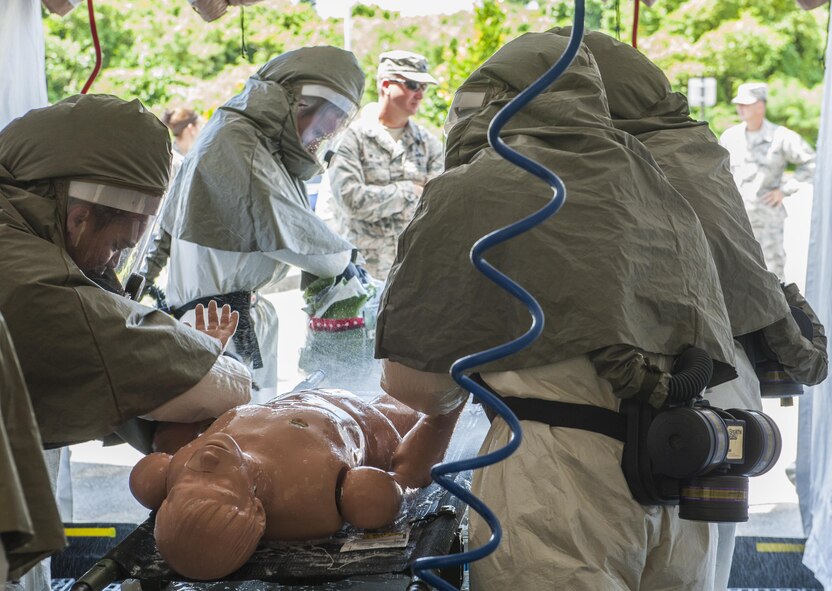 Airmen practice decontaminating a patient during an exercise at the Kadena medical clinic, Aug. 30, 2016, at Kadena Air Base, Japan. The Airmen were timed to gage their effectiveness at setting up a decontamination tent and treatment of patients. (U.S. Air Force photo by Airman 1st Class Nick Emerick) 
