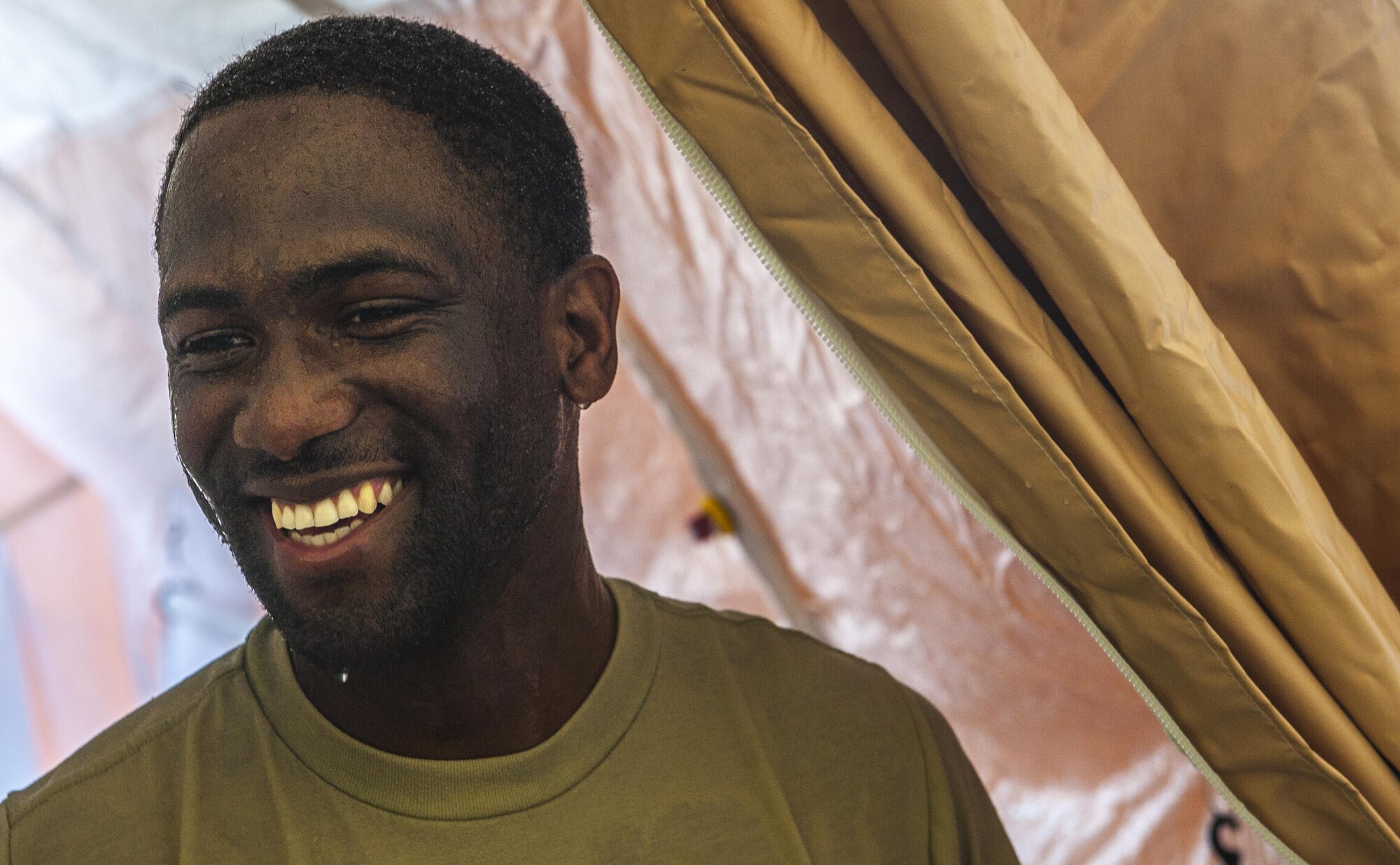 Tech. Sgt. Terry Mitchel, a dental technician with the 18th Dental Squadron, exits a decontamination tent during an exercise at the Kadena medical clinic, Aug. 30, 2016, at Kadena Air Base, Japan. Airmen from across the Pacific Air Forces came to Kadena to participate in the decontamination exercise. (U.S. Air Force photo by Airman 1st Class Nick Emerick)