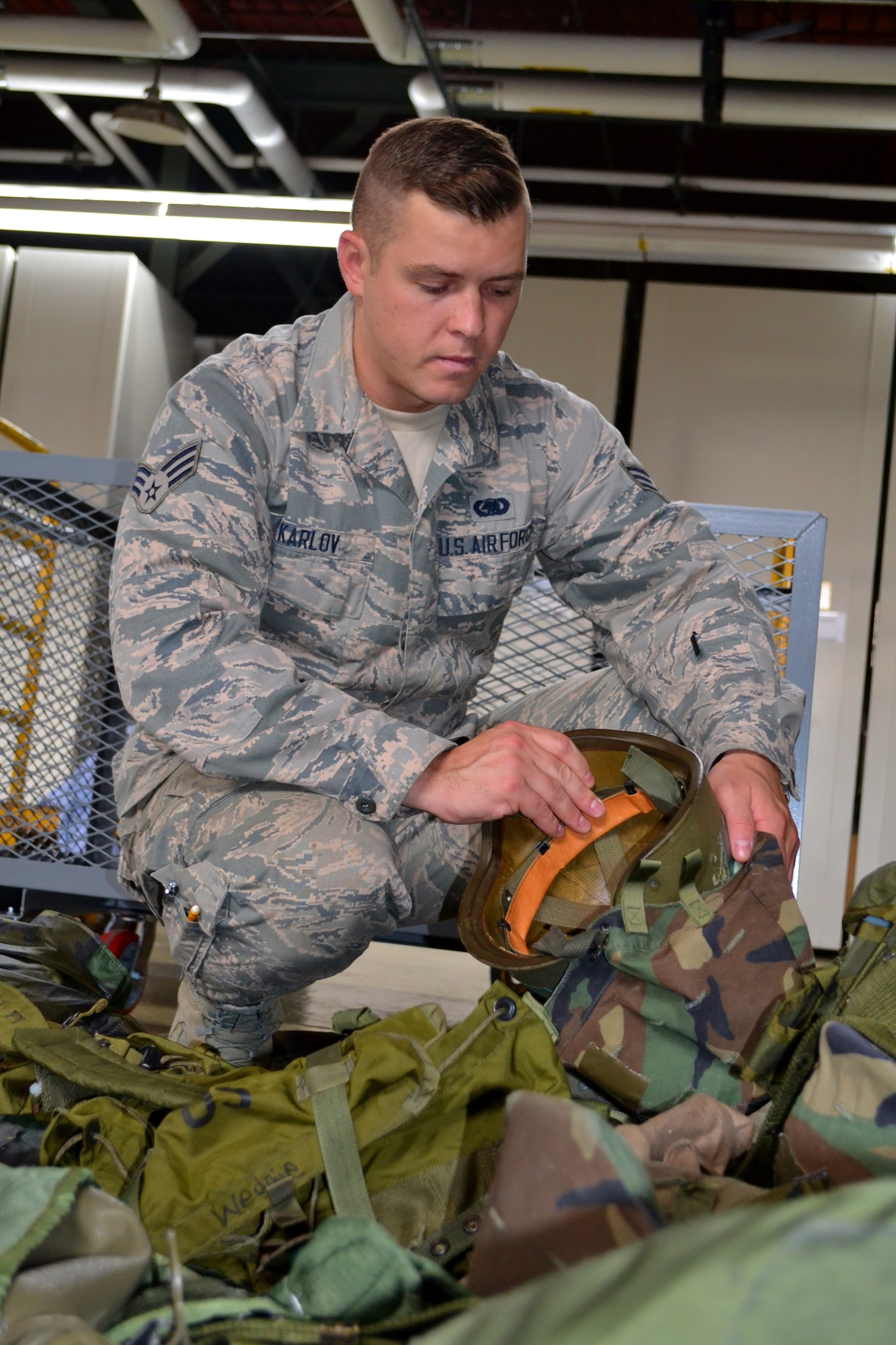 Senior Airman Igor Karlov, 111th Logistics Readiness Squadron supply technician, sorts through outdated military gear at Horsham Air Guard Station, Pa., Sept. 6, 2016. Karlov, part of the Pa. Air National Guard, was the first-ever Guardsman to receive The American Legion Spirit of Service Award in the 17 years it has been awarded to U.S. military members. (U.S. Air National Guard photo by Tech. Sgt. Andria Allmond)

