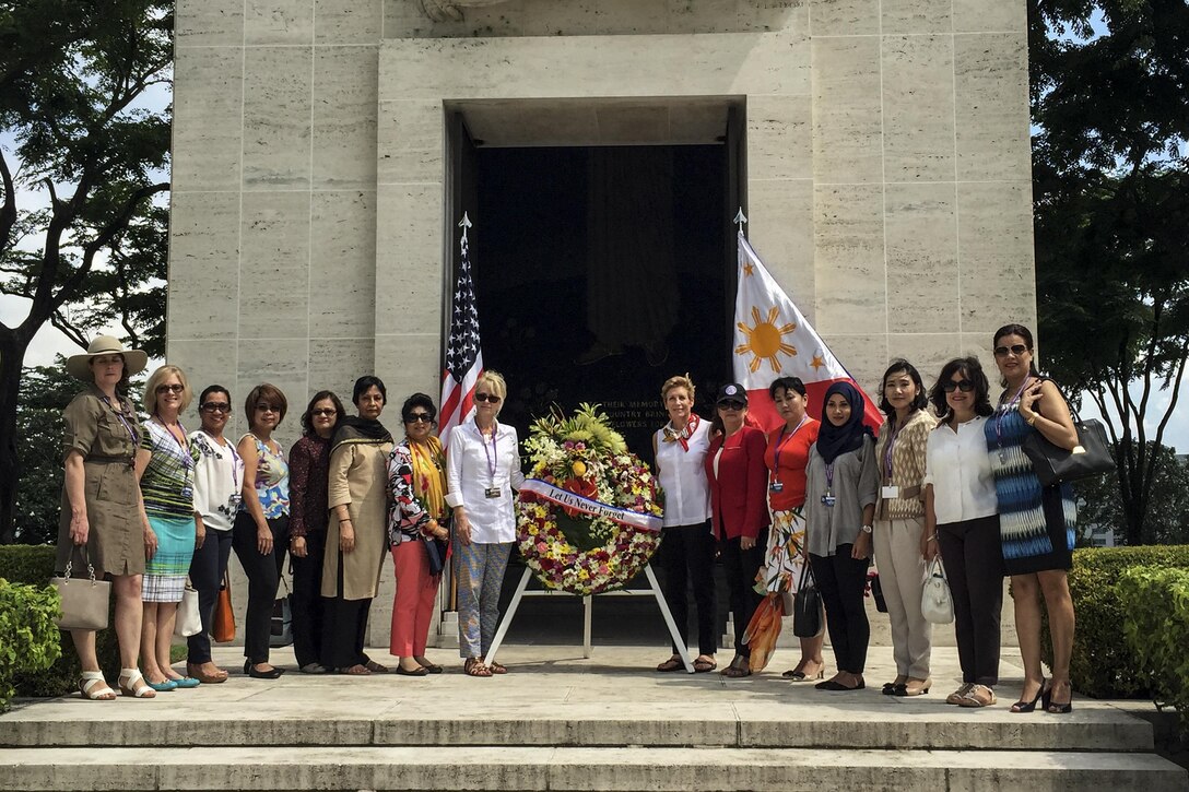 Ellyn Dunford, wife of Marine Corps Gen. Joe Dunford, chairman of the Joint Chiefs of Staff, and spouses of defense ministers attending the 2016 Chiefs of Defense Conference present a wreath at the Manila American Cemetery and Memorial in Manila, Philippines, Sept. 6, 2016. DoD photo by Lisa Ferdinando