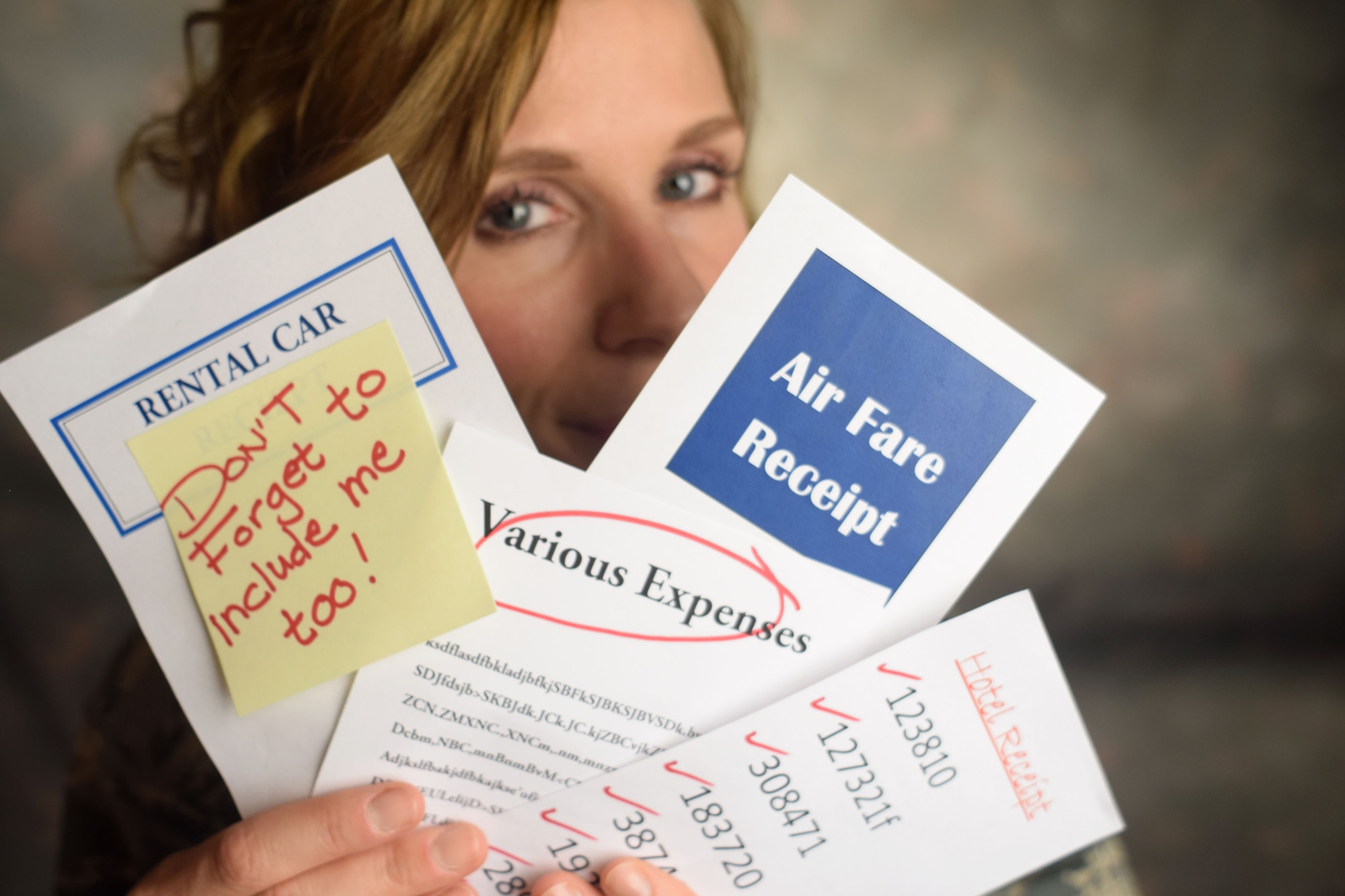 Tech. Sgt. Andria Allmond, a 111th Attack Wing photojournalist, poses with faux receipts at Horsham Air Guard Station, Pa., Sept. 1, 2016.