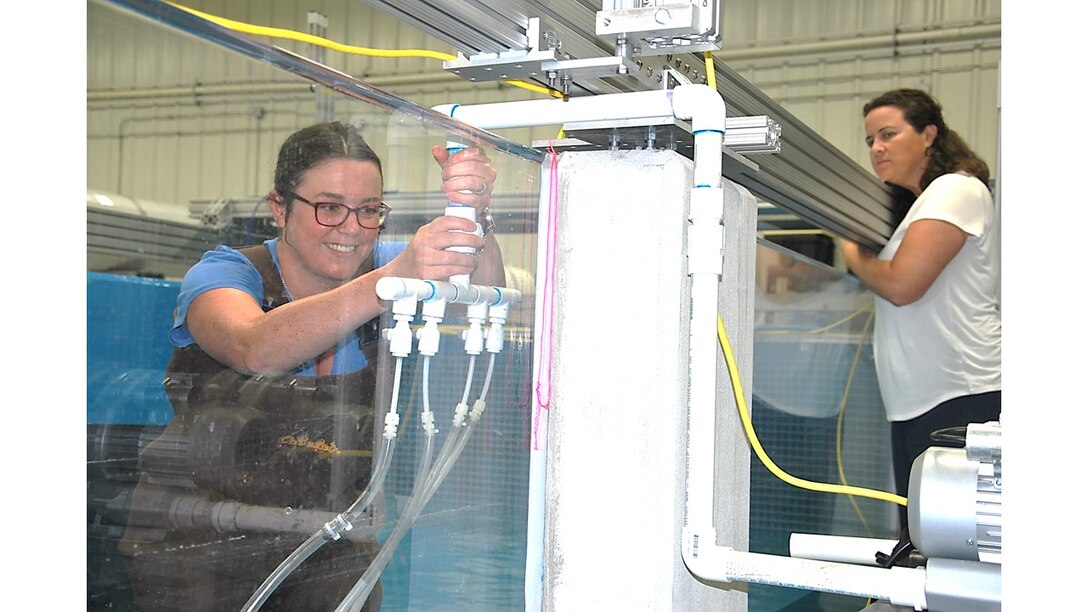 San Francisco District’s Cynthia Fowler adjusts the air bubbles’ curtain at the Engineer Research and Development Center’s 33,000 gallon fish flume for invasive and native species research, as her adviser, Environment Laboratory’s Research Ecologist Dr. Christa Woodley, observes. As one of eight district researchers and scientists selected for ERDC University’s inaugural class, Fowler is participating in a six month collaborative research project at the Vicksburg, Mississippi, campus. As part of her master’s degree program, she is studying the effects of hydraulic hopper dredging on all fishes with EL Advisers Dr. David Smith and Woodley.