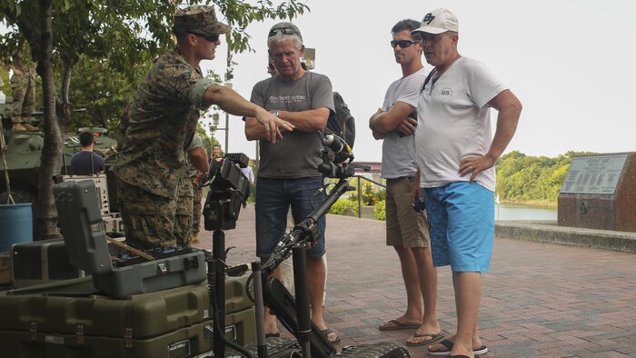 Sgt. Derek Turner, left, an explosive ordnance disposal technician with EOD Company, 8th Engineer Support Battalion, based out of Camp Lejeune, N.C., shows Nashville, Tenn. residents the MK 2 Mod 0 Talon during a static display in Nashville, Sept. 6. Marine Week Nashville celebrates the contributions of local Marines whose service to our nation has protected and preserved our way of life for hundreds of years.