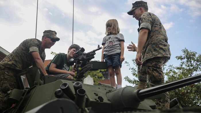 Marines with 2nd Light Armored Reconnaissance Battalion based out of Camp Lejeune, N.C., show children an M240B machine gun mounted on a Light Armored Vehicle during a static display in Nashville, Tenn., Sept. 6. Marine Week Nashville celebrates the contributions of local Marines whose service to our nation has protected and preserved our way of life for hundreds of years.