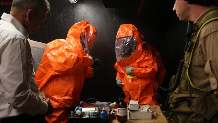 Retired Israeli Defense Force Brig. Gen. Moshe Edri, left, Assistant Minister of Defense for chemical, biological, radiological and nuclear defense,  Government of Israel watches Cpls. Gunnar Naughton (left) and Bryce Ware (right), team members with Identification and Detection Platoon, Reaction Force Company, Chemical Biological Incident Response Force, demonstrate how to sample agents in a contaminated environment during an official visit Aug. 29, 2016. CBIRF hosted officials from the Israeli Ministry of Defense for chemical, biological, radiological and nuclear defense to showcase their skills and techniques for responding to CBRN threats or events worldwide.