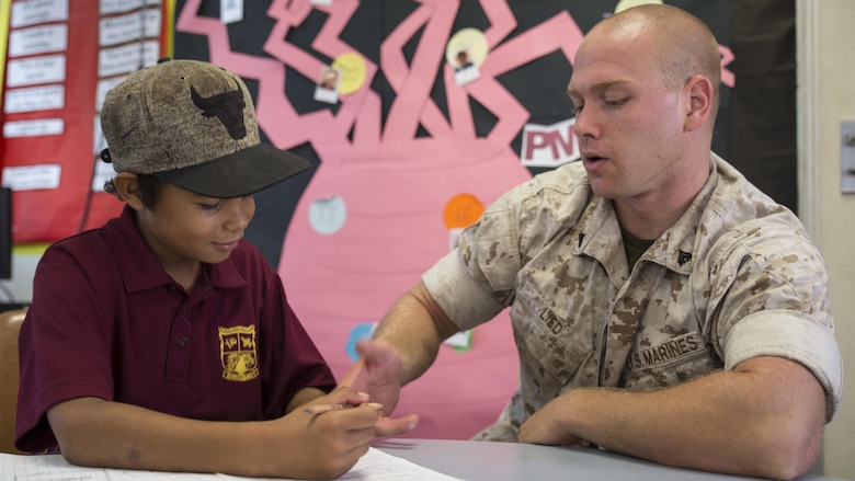 U.S. Marine Corps Cpl. Landis Lied, an embarkation and logistics specialist assigned to Marine Fighter Attack Squadron 122, helps a student with multiplication at MacFarlane Primary School in Katherine, Northern Territory, Australia, Sept. 1, 2016. Marines are invited to mentor and teach students every iteration of Southern Frontier, a three week unit level training conducted by U.S. Marines at Royal Australian Air Force Base Tindal. The primary school’s student population is 92 percent indigenous and is very transient. Classes are designed to provide students structure and a consolidated education in literacy, numeracy, respect and behavior management.