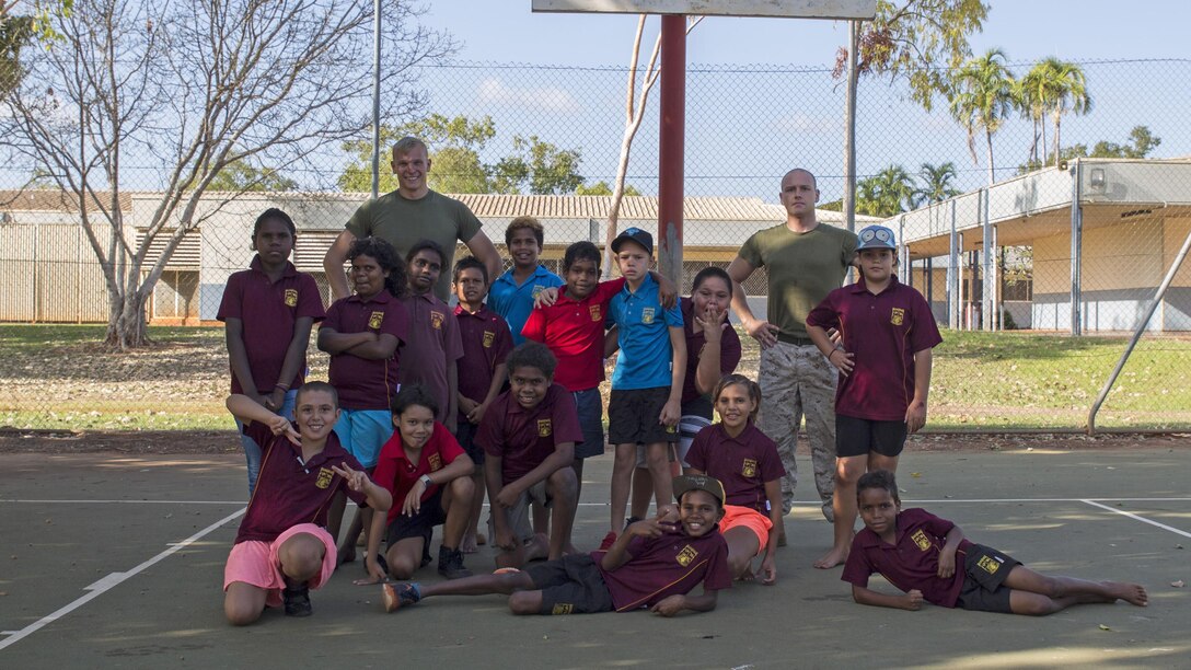 U.S. Marine Corps Cpl. Cody Braunscheidel, left, an aviation logistics information management systems specialist, and Cpl. Landis Lied, right, an embarkation and logistics specialist assigned to Marine Fighter Attack Squadron 122, pose with students from MacFarlane Primary School in Katherine, Northern Territory, Australia, Sept. 1, 2016. Marines are invited to mentor, teach and serve as role models to the students every iteration of Southern Frontier, a three week unit level training conducted by U.S. Marines at Royal Australian Air Force Base Tindal. With a population of 92 percent indigenous students, the school provides a structured educational environment to the students.