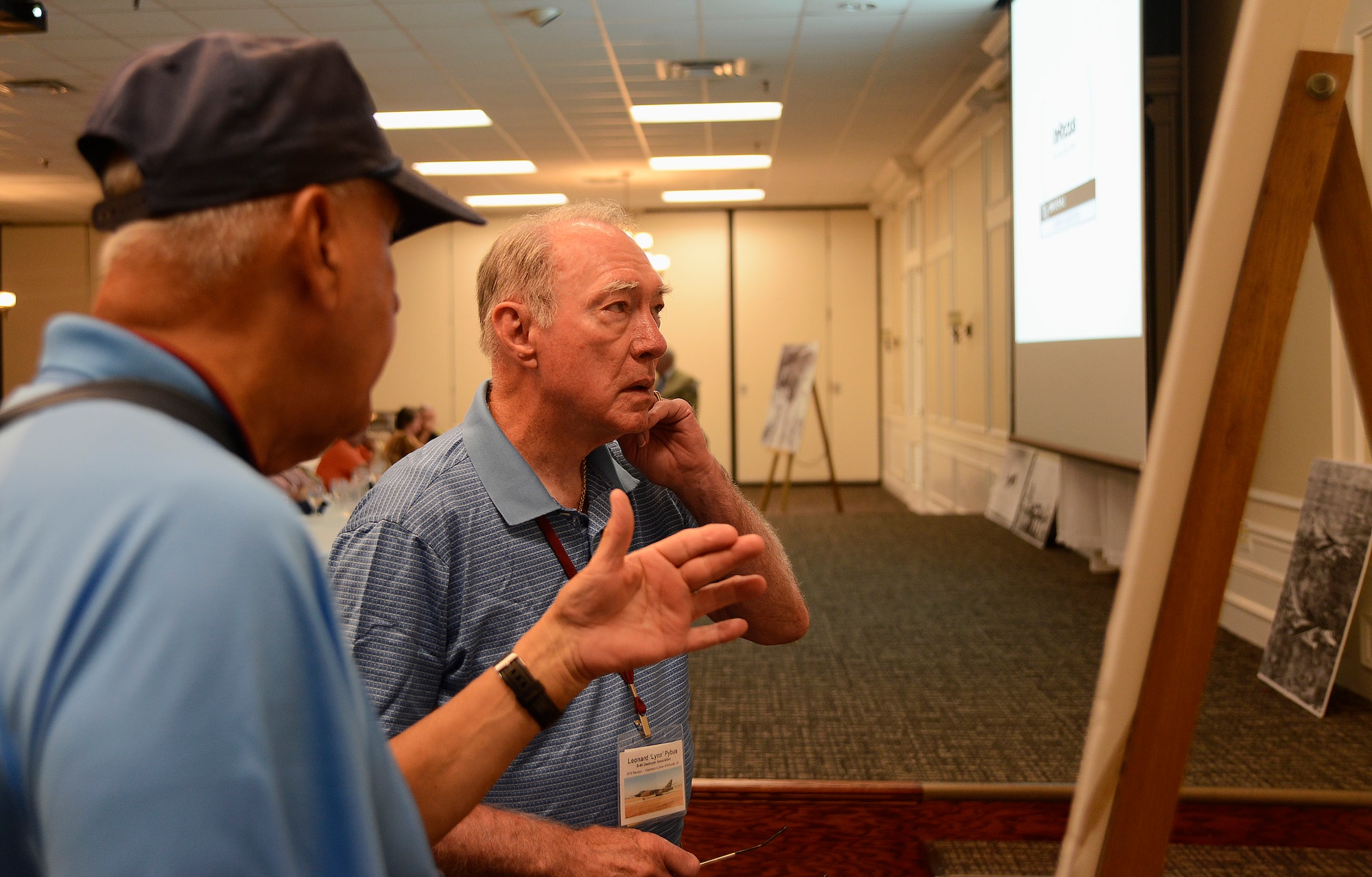 Leonard Pybus, a B-66 Destroyer Association member looks at a historical photo with a fellow veteran at Shaw Air Force Base, S.C., Aug. 30, 2016. Some of the B-66 veterans at this reunion have not seen Shaw AFB for almost 50 years. (U.S. Air Force photo by Airman BrieAnna Stillman)