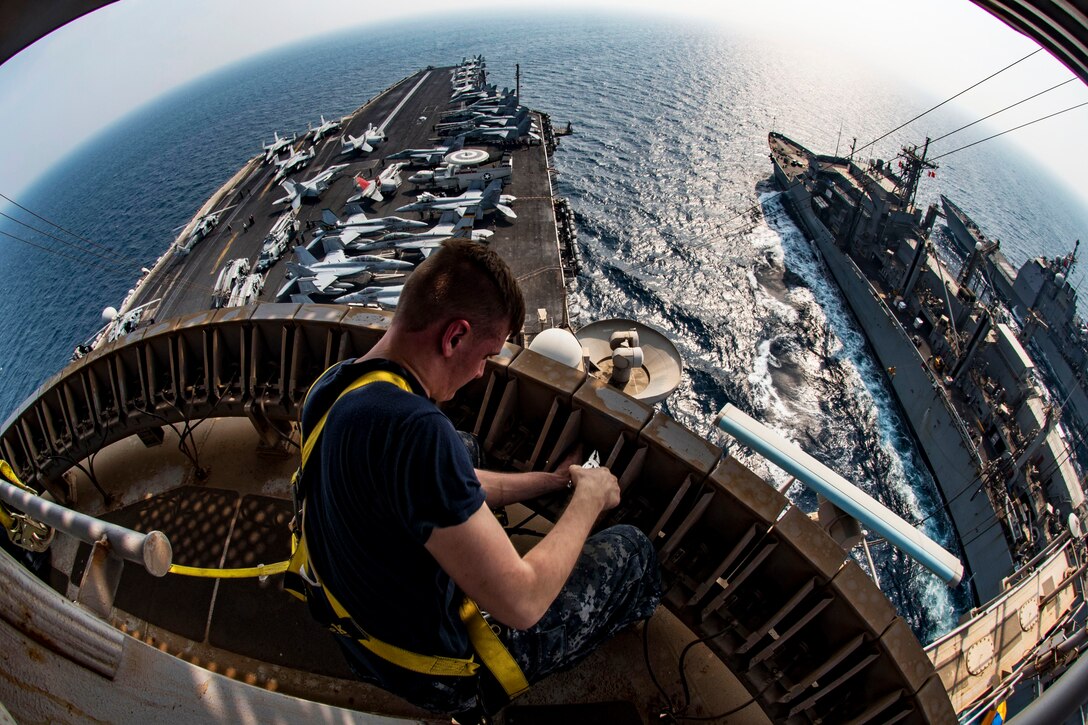 Navy Petty Officer 3rd Class Brian Evans maintains an AS-3134/UPX, an antenna system while working aloft during a replenishment involving the USS Dwight D. Eisenhower, the USS Monterey and the USNS Arctic in the Persian Gulf, Sept. 2, 2016. The Eisenhower is supporting Operation Inherent Resolve, maritime security operations and theater security cooperation efforts in the U.S. 5th Fleet area of operations. Navy photo by Petty Officer 3rd Nathan T. Beard

