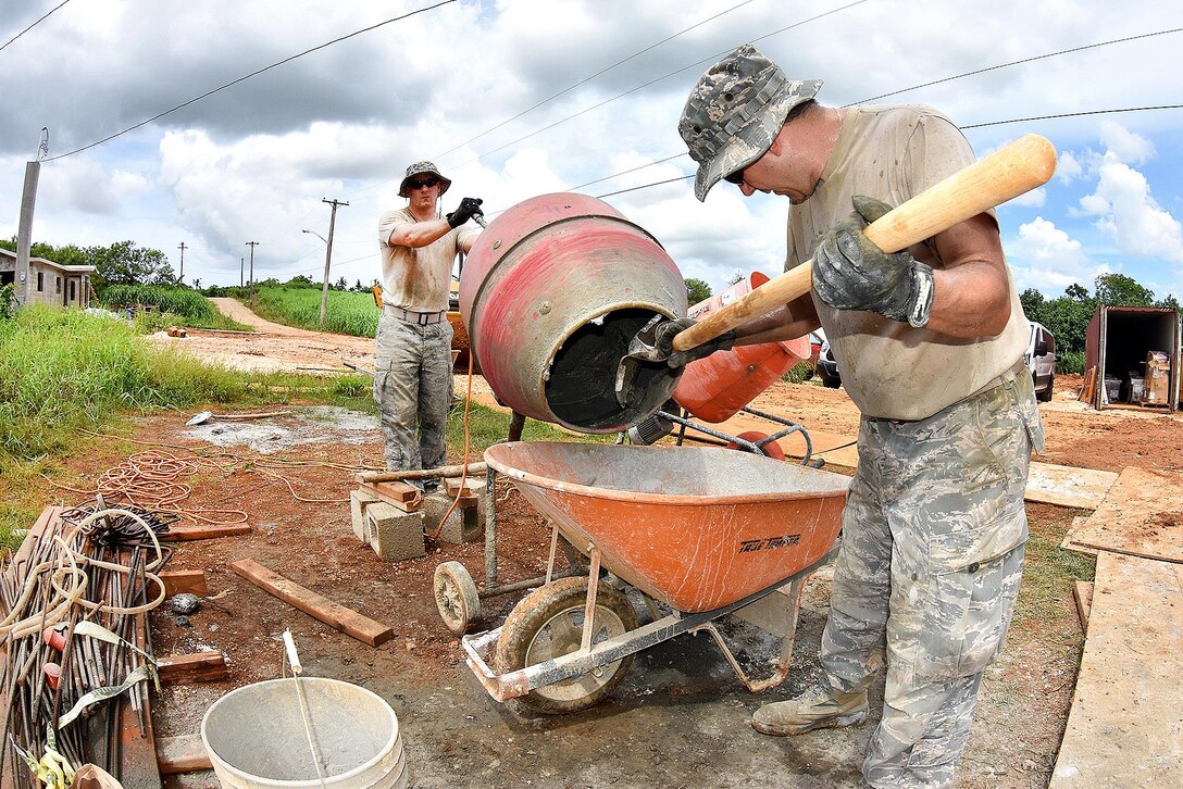 Air Force Senior Airman John Bender, foreground, and Maj. Jeremiah Buckenberger mix cement for skim coating which strengthens walls for extreme weather conditions during an Innovative Readiness Training project in Inarajan, Guam, Sept. 1, 2016. Bender and Buckenberger are assigned to the Rhode Island Air National Guard’s 143d Civil Engineering Squadron. Air National Guard photo by Master Sgt. John V. McDonald