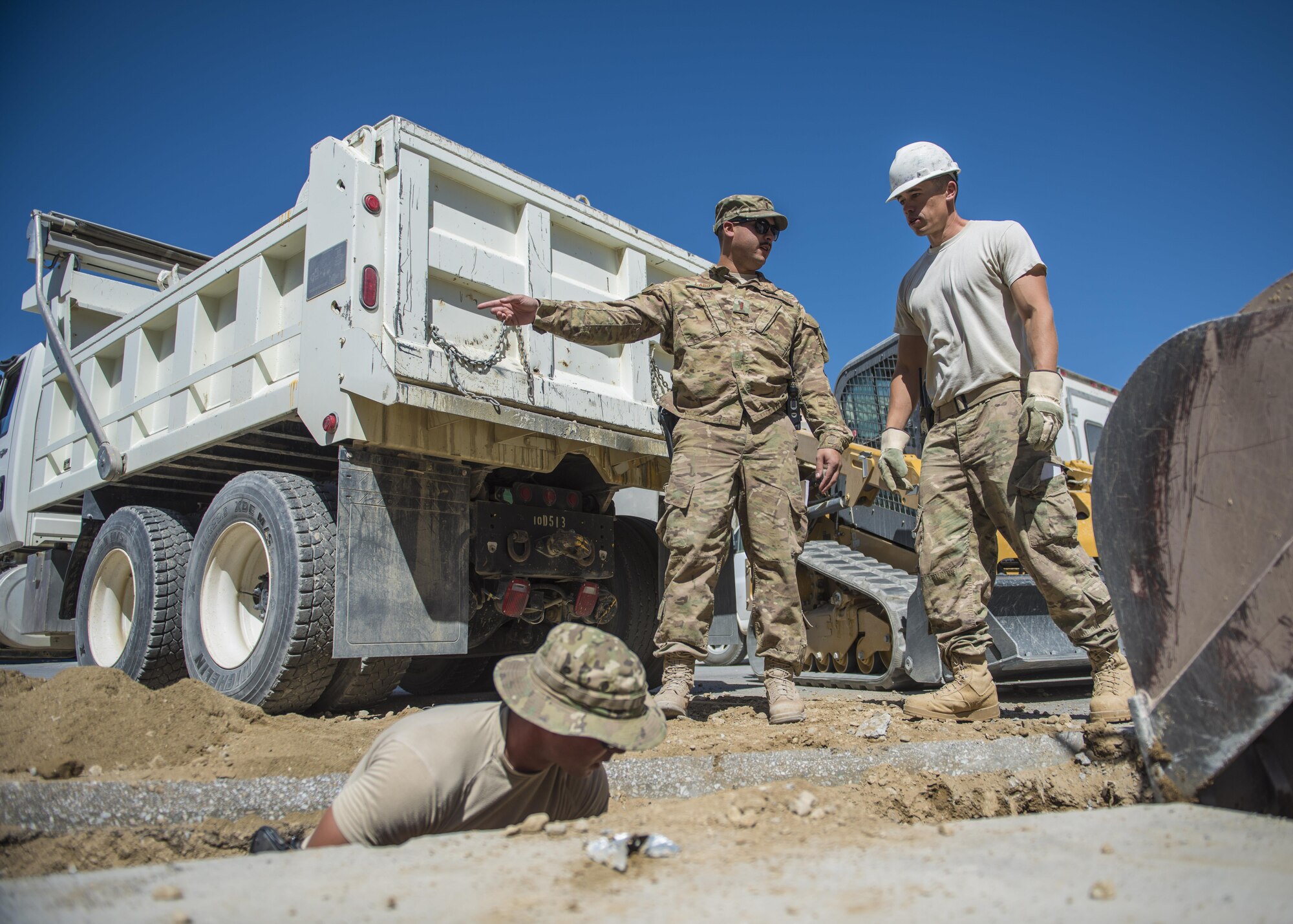 Pavement and equipment technicians from the 455th Expeditionary Civil Engineer Squadron, dig a hole at a construction site, Bagram Airfield, Afghanistan, Sept. 7, 2016. The site was prepared for a new drainage system designed to collect excess water and precipitation. (U.S. Air Force photo by Senior Airman Justyn M. Freeman)