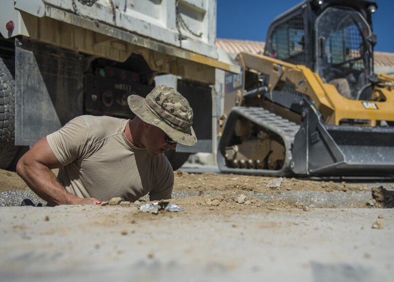 Staff Sgt. Jacob Skjei, 455th Expeditionary Civil Engineer Squadron pavements and equipment technician, digs dirt out of a ditch, Bagram Airfield, Afghanistan, Sept. 7, 2016. The engineers, otherwise known as “Dirt Boys”, worked to construct a new drainage system at the passenger’s terminal. (U.S. Air Force photo by Senior Airman Justyn M. Freeman)