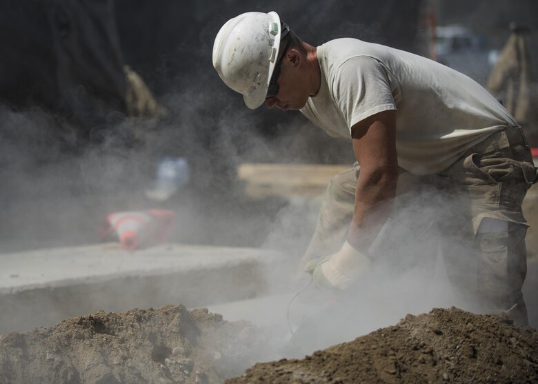 Staff Sgt. Casey Epps, 455th Expeditionary Civil Engineer Squadron pavements and equipment technician, saws through concrete, Bagram Airfield, Afghanistan, Sept. 7, 2016. The ECES technicians dug up the ground to create a new drainage system located at the passengers terminal. (U.S. Air Force photo by Senior Airman Justyn M. Freeman)