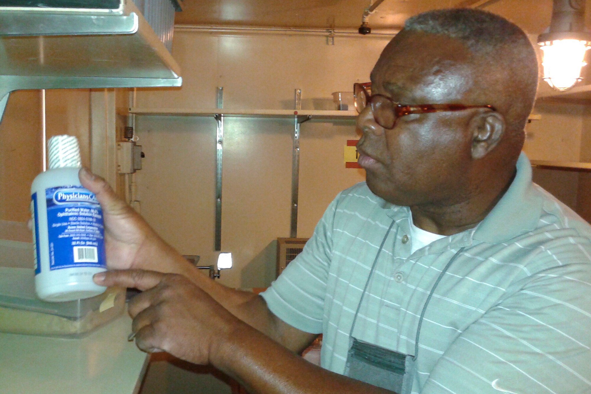PETERSON AIR FORCE BASE, Colo. – Earl Jones, 21st Logistics Readiness Squadron Hazardous Materials supervisor, checks the expiration date on a bottle of eyewash solution at the HAZMAT yard on Peterson Air Force Base, Colo., Aug. 16, 2016. The HAZMAT shop accounts for all materials from receipt until they are entirely depleted so they are less likely to cause harm or damage. (U.S. Air Force photo by Philip Carter)