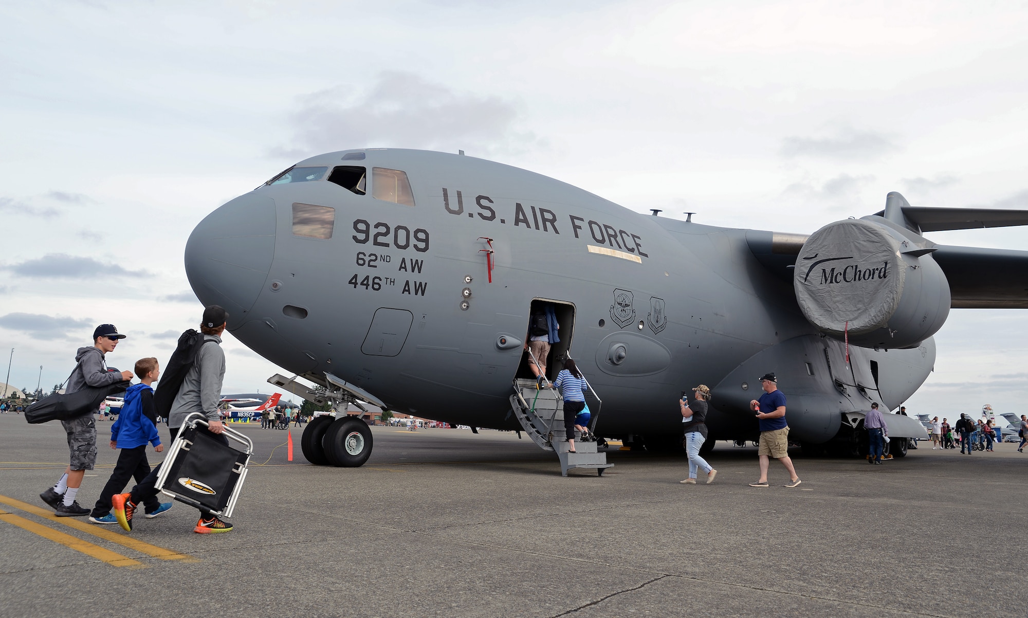 Attendees of the JBLM Airshow and Warrior Expo enter a C-17 Globemaster III to tour the aircraft Aug. 28, 2016, at Joint Base Lewis-McChord, Wash. While viewing the C-17, airshow participants were briefed about some of the aircraft’s capabilities, including air medevac and airdrop. (U.S. Air Force photo/Senior Airman Jacob Jimenez) 