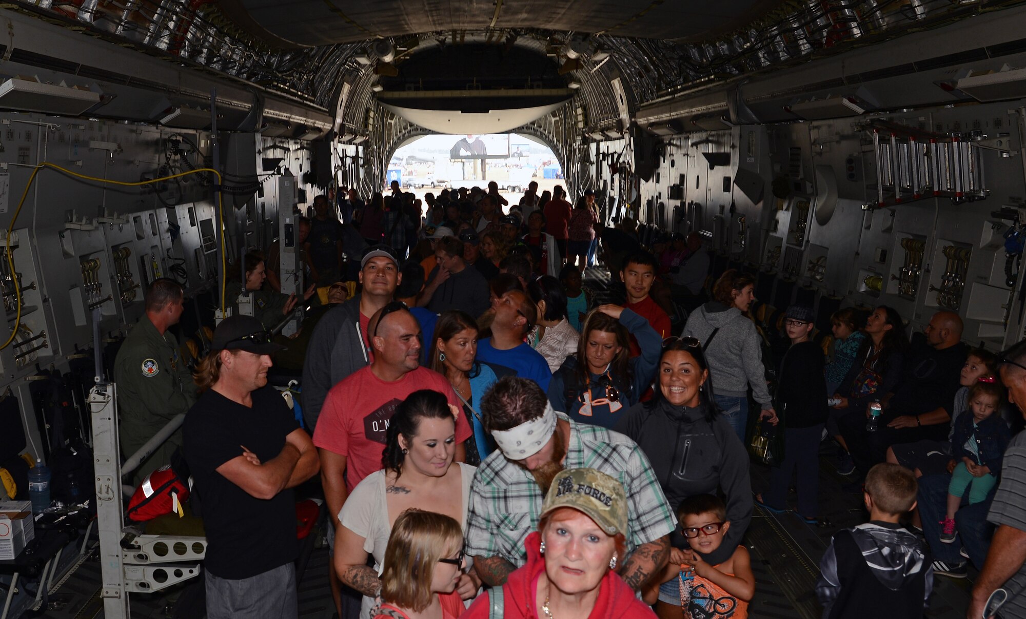 JBLM Airshow and Warrior Expo attendees wait in line to see the flight deck of a C-17 Globemaster III Aug. 28, 2016, at Joint Base Lewis-McChord, Wash. More than 100 air show attendees waited up to an hour to climb aboard the C-17’s flight deck. (U.S. Air Force photo/Senior Airman Jacob Jimenez)  