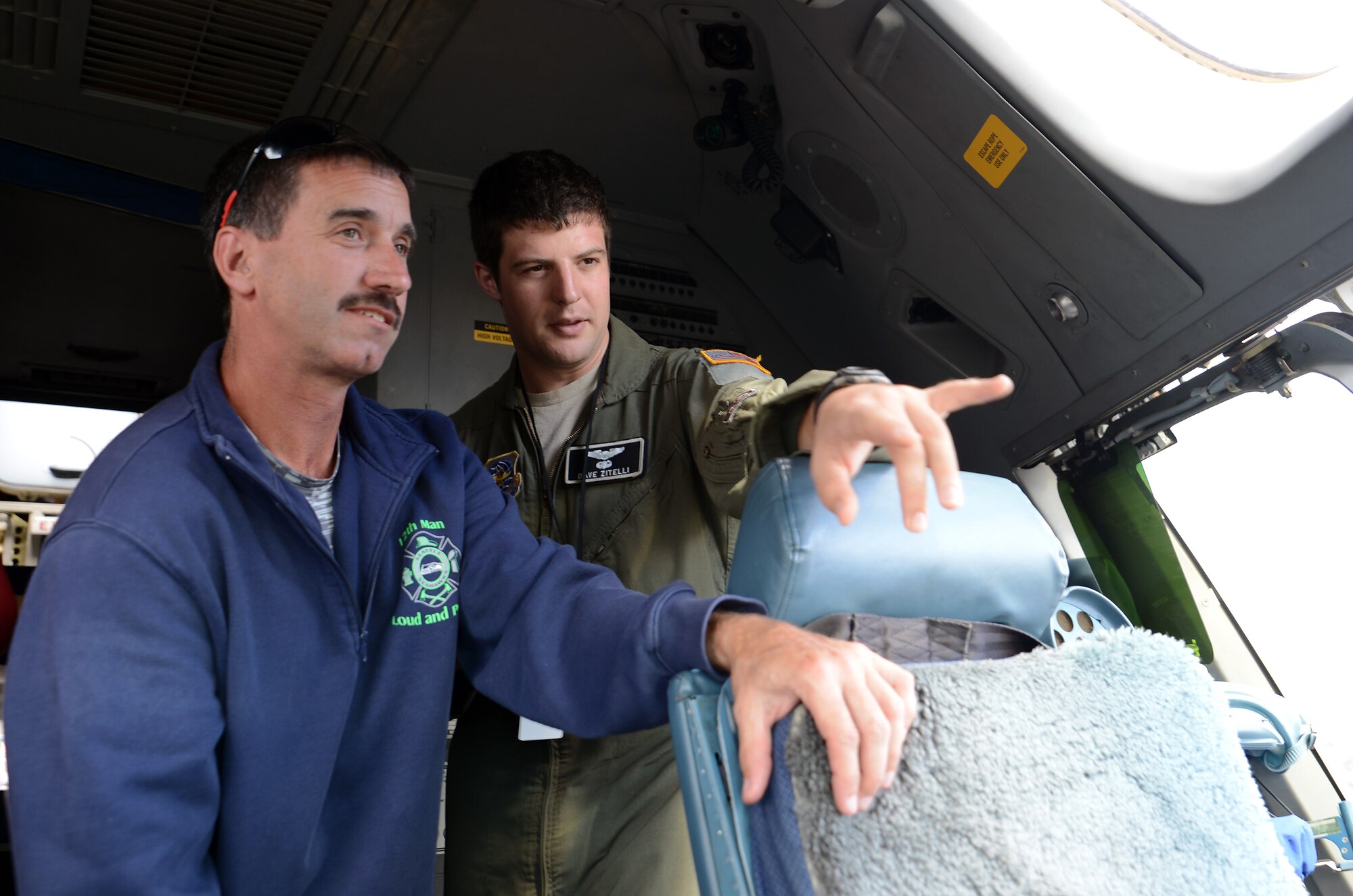 Capt. Dave Zitelli, 8th Airlift Squadron pilot, shows an attendee of the JBLM Airshow and Warrior Expo the flight deck of a C-17 Globemaster III Aug. 27, 2016, at Joint Base Lewis-McChord, Wash. Air show attendees were allowed to tour the C-17 and have their questions answered by pilots and loadmasters. (U.S. Air Force photo/Senior Airman Jacob Jimenez)