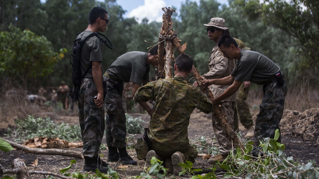 A U.S. Marine, Australian Army soldier, and People’s Liberation Army soldiers build a signal fire during Exercise Kowari at Daly River Region, Northern Territory, Australia, Sept. 3, 2016. The purpose of Exercise Kowari is to enhance the United States, Australia, and China’s friendship and trust, through trilateral cooperation in the Indo-Asia-Pacific region.