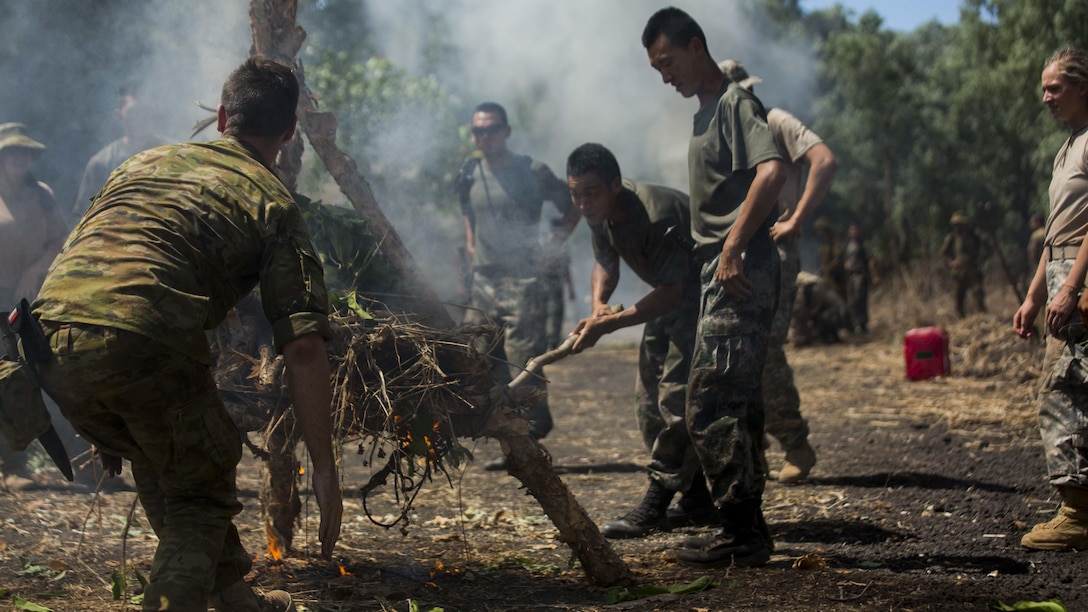 An Australian Army soldier and People’s Liberation Army soldiers build a signal fire during Exercise Kowari at Daly River Region, Northern Territory, Australia, Sept. 3, 2016. The purpose of Exercise Kowari is to enhance the United States, Australia, and China’s friendship and trust, through trilateral cooperation in the Indo-Asia-Pacific region.