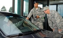 Col. Eric Brandes, 512th Maintenance Group commander, right, talks to drivers as they enter the base Sept. 1, 2016, at the north gate on Dover Air Force Base, Del. As part of the 436th and 512th Airlift Wings Labor Day safety send off, Tech Sgt. Marcelino Ruiz, 436th Security Forces Squadron training NCO in charge, center, checked identification cards and seatbelt usage, along with 436th AW Safety Office personnel. They also reminded drivers and passengers to be safe over the Air Mobility Command's family day and Labor Day holiday weekend. (U.S. Air Force photo by Roland Balik)