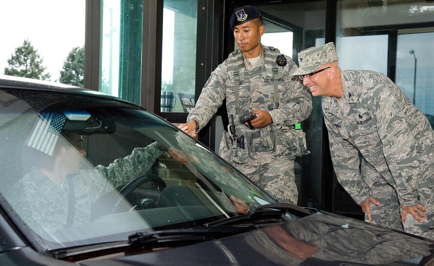 Col. Eric Brandes, 512th Maintenance Group commander, right, talks to drivers as they enter the base Sept. 1, 2016, at the north gate on Dover Air Force Base, Del. As part of the 436th and 512th Airlift Wings Labor Day safety send off, Tech Sgt. Marcelino Ruiz, 436th Security Forces Squadron training NCO in charge, center, checked identification cards and seatbelt usage, along with 436th AW Safety Office personnel. They also reminded drivers and passengers to be safe over the Air Mobility Command's family day and Labor Day holiday weekend. (U.S. Air Force photo by Roland Balik)