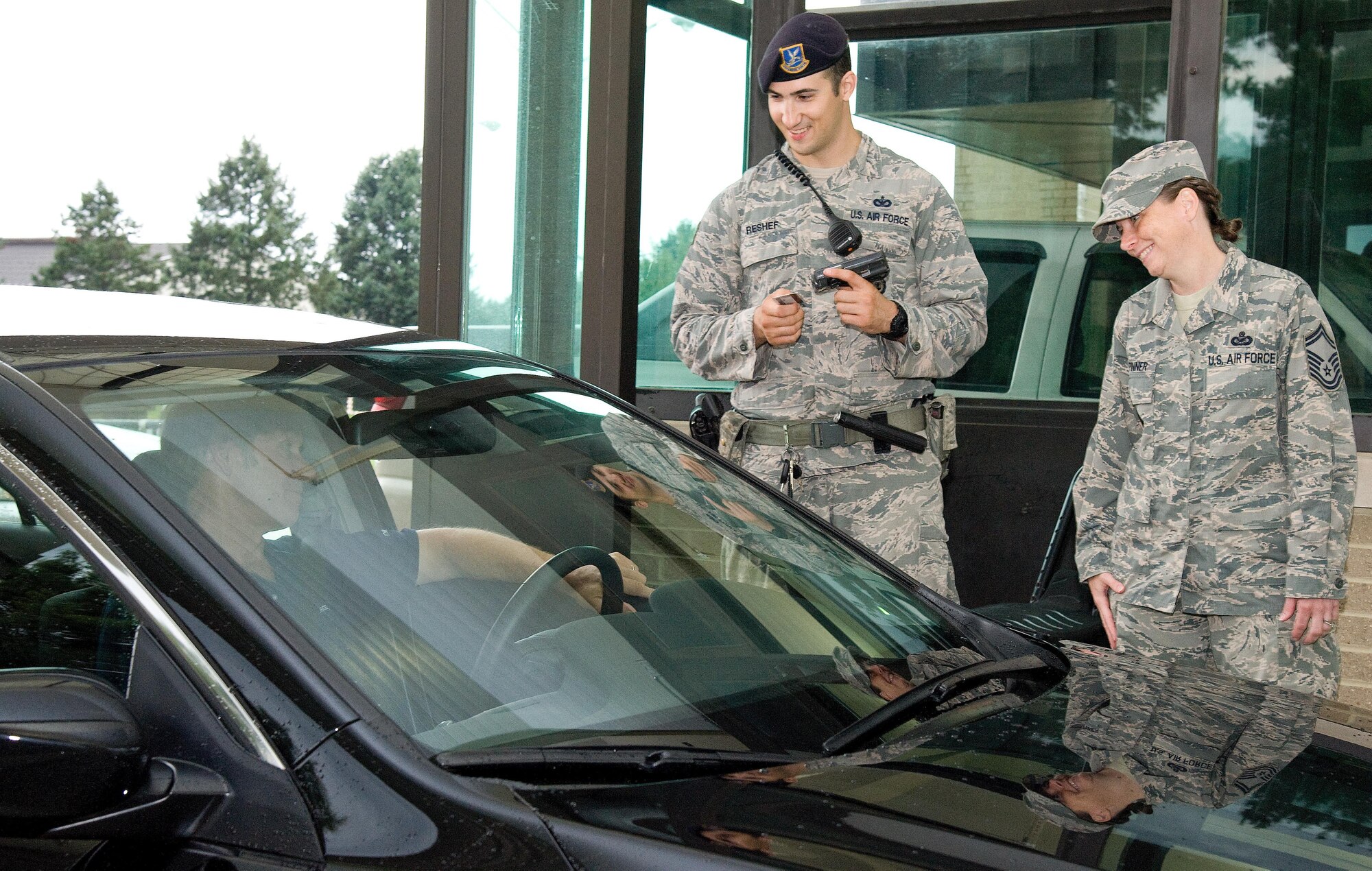 Staff Sgt. Daniel Reshef, 436th Security Forces Squadron unit scheduler, center, and Senior Master Sgt. Kimberly Spinner, 436th Airlift Wing Public Affairs superintendent, right, greet a driver as he enters the base Sept. 1, 2016, at the north gate on Dover Air Force Base, Del. As part of the 436th and 512th Airlift Wings Labor Day safety send off, senior leadership and the 436th AW Safety Office personnel reminded Team Dover members to be safe over the four-day weekend. (U.S. Air Force photo by Roland Balik)