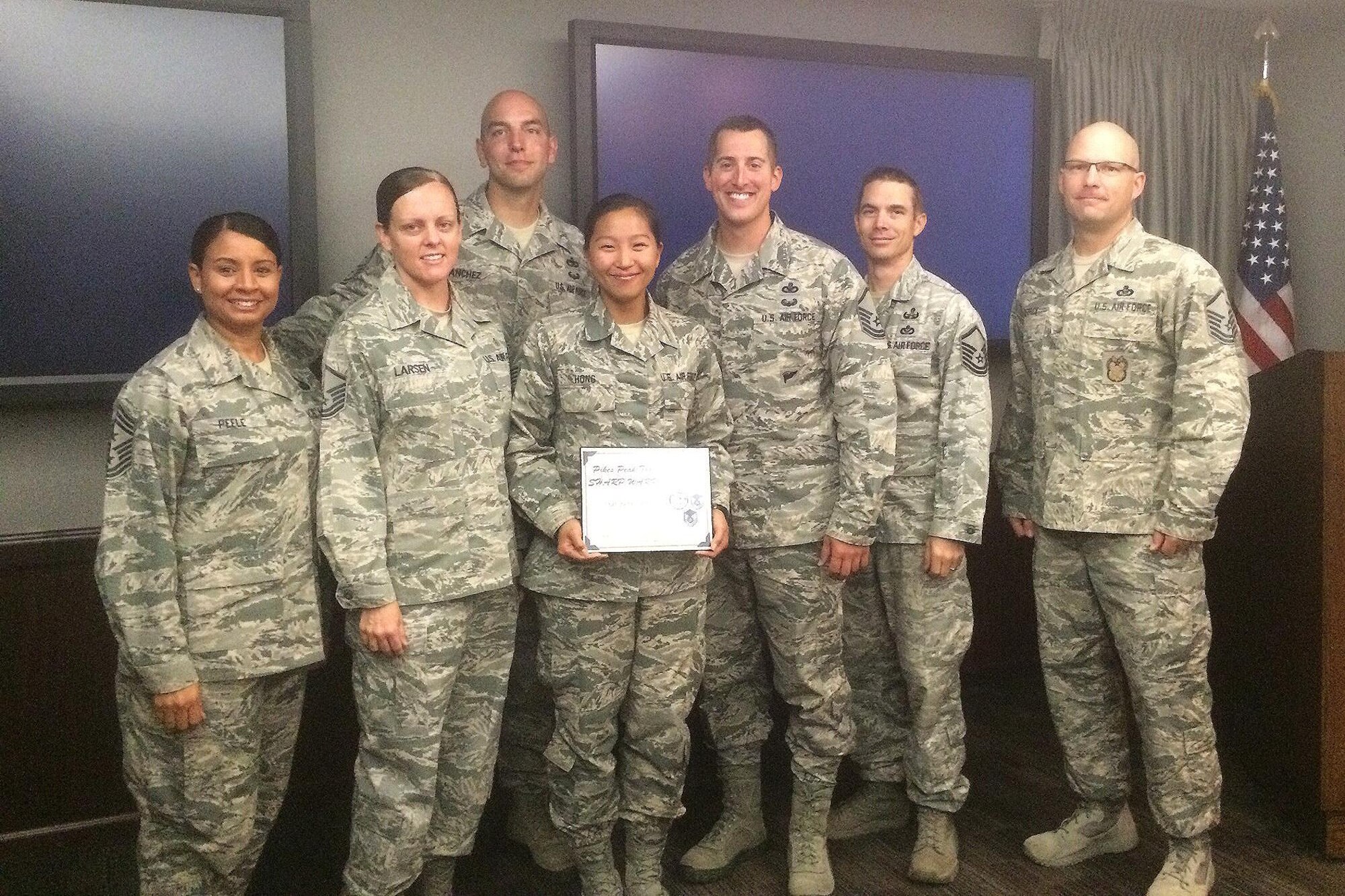 PETERSON AIR FORCE BASE, Colo. – Staff Sgt. Rebecca Hong, 21st Space Wing command chief executive assistant, receives the Sharp Warrior Award from the Pike's Peak Top 3 council at Peterson Air Force Base, Colo., Aug. 29, 2016. Hong received the award for coordinating all distinguished visits to base in July, providing outstanding customer service to private organizations on base, and coordinating on all events as a conduit for the Chief’s Group to the command chief. (Courtesy photo)