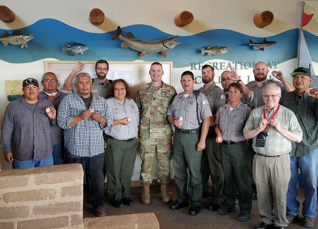 COCHITI LAKE, N.M. -- District employees at Cochiti Lake show their commander’s coins, Aug. 19, 2016. District Commander Lt. Col. Booth presented the coins to recognize the employees’ role in the successful outcome of the two rescues.

(L-R): Wayne Arquero; Chuck Naranjo; Myron Suina; Nicholas Parks; Roberta Chavez; Lt. Col. James Booth; Richard Gutierrez; Michael Vollmer; Bob Garcia; Trevor Wallin; Chris Dohmen; Mark Baker; Dru Ahsona
