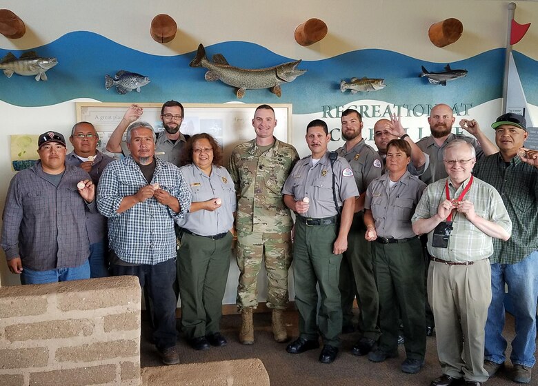 COCHITI LAKE, N.M. -- District employees at Cochiti Lake show their commander’s coins, Aug. 19, 2016. District Commander Lt. Col. Booth presented the coins to recognize the employees’ role in the successful outcome of the two rescues.

(L-R): Wayne Arquero; Chuck Naranjo; Myron Suina; Nicholas Parks; Roberta Chavez; Lt. Col. James Booth; Richard Gutierrez; Michael Vollmer; Bob Garcia; Trevor Wallin; Chris Dohmen; Mark Baker; Dru Ahsona
