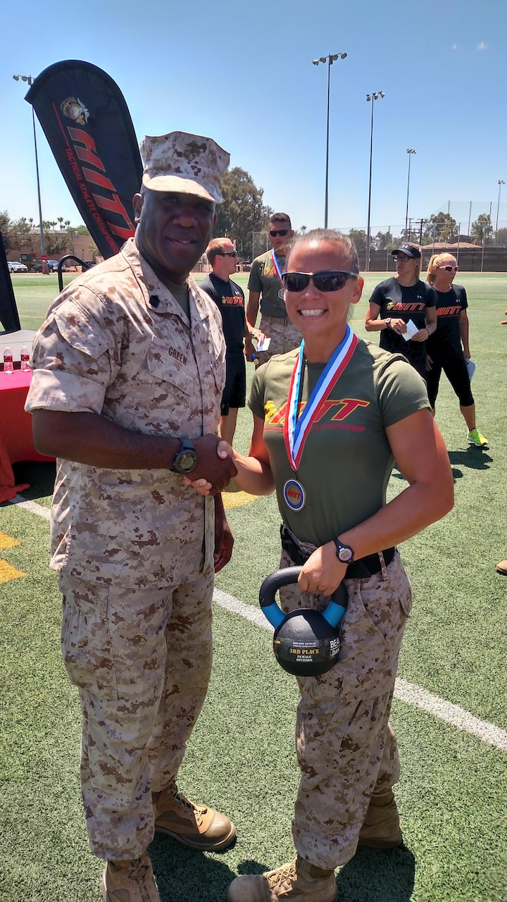 Sergeant Major of the Marine Corps Ronald Green congratulates Marine Corps Staff Sgt. Amanda Jenks for her third place finish at the 2016 High Intensity Tactical Training Tactical Athlete Championships at Marine Corps Air Station Miramar, Calif., Aug. 18, 2016. Courtesy photo