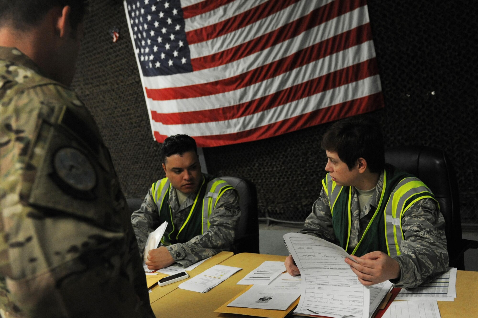 U.S. Air Force Airman 1st Class Anthony Licea, 19th Force Support Squadron decorations technician, and U.S. Air Force Airman 1st Class Xochitl Medina, 19th Force Support Squadron relocations technician, review paperwork during a personnel deployment function line Sept. 1, 2016, at Little Rock Air Force Base, Ark. During a PDF line, Airmen have their records reviewed prior to deploying. (U.S. Air Force photo by Senior Airman Mercedes Taylor) 