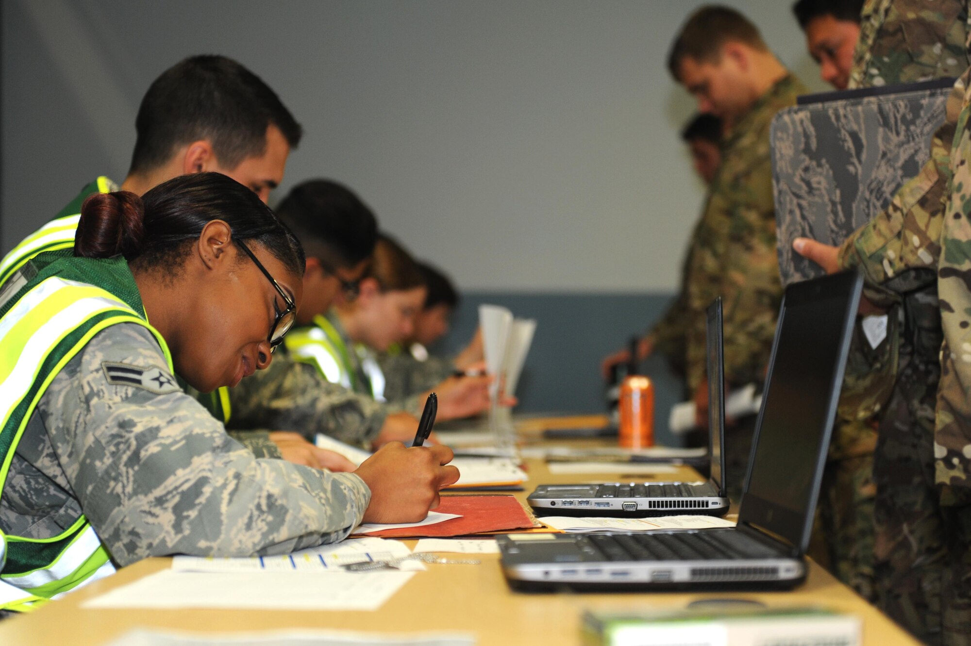 U.S. Air Force Airman First Class Mariah Manning, 19th Force Support Squadron customer support specialist, looks over paperwork for service members Sept. 1, 2016, at a personnel deployment function line on Little Rock Air Force Base, Ark. Airmen from the 19th FSS ensured Airmen were ready to deploy, maintaining mission readiness. U.S Air Force photo by Airman Grace Nichols) 