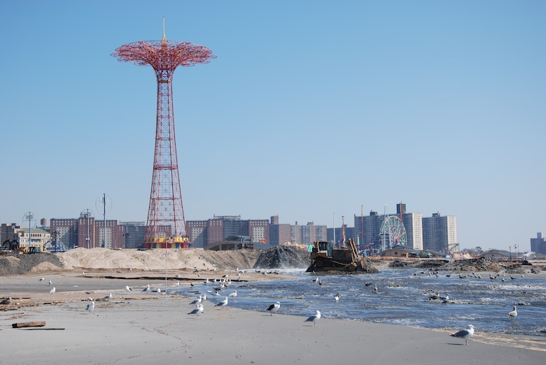 Sand being pumped onto Coney Island Beach, New York. 