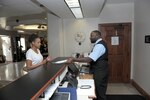 Kevin Harris (right), guest service representative, assists a customer, Aug. 24, 2016 at the Joint Base San Antonio-Randolph Inn. The Randolph Inn takes care of active-duty members, retirees, Department of Defense employees and families. The inn offers four-star distinguished visitor suites, distinguished visitor quarters, visiting quarters and temporary living facilities with one to three bedrooms that are now pet-friendly.  
