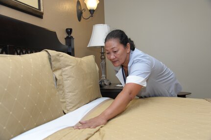 Norma Timbol, housekeeper, makes a bed, Aug. 24, 2016 at the Joint Base San Antonio-Randolph Inn. The Randolph Inn takes care of active-duty members, retirees, Department of Defense employees and families. The inn offers four-star distinguished visitor suites, distinguished visitor quarters, visiting quarters and temporary living facilities with one to three bedrooms that are now pet-friendly. 