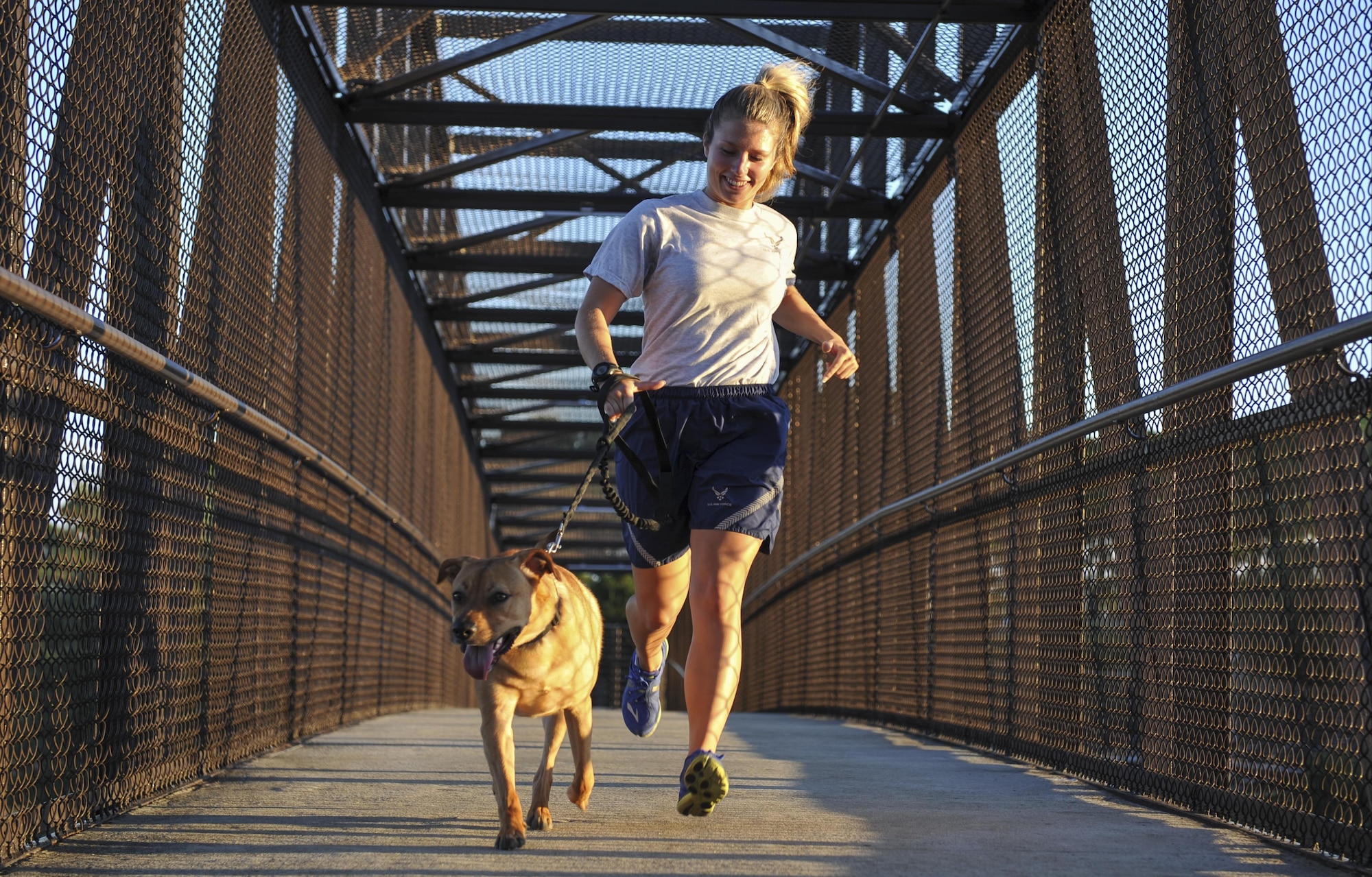 Senior Airman Rebecca Chamberlain, a paralegal with the 1st Special Operations Wing Legal Office, runs with her dog, Cecil, at Hurlburt Field, Fla., Aug. 30, 2016. Chamberlain often runs with Cecil as she prepares for the 20th Annual Air Force Marathon scheduled to take place Sept. 17, at Wright-Patterson Air Force Base. (U.S. Air Force photo by Airman 1st Class Joseph Pick)
