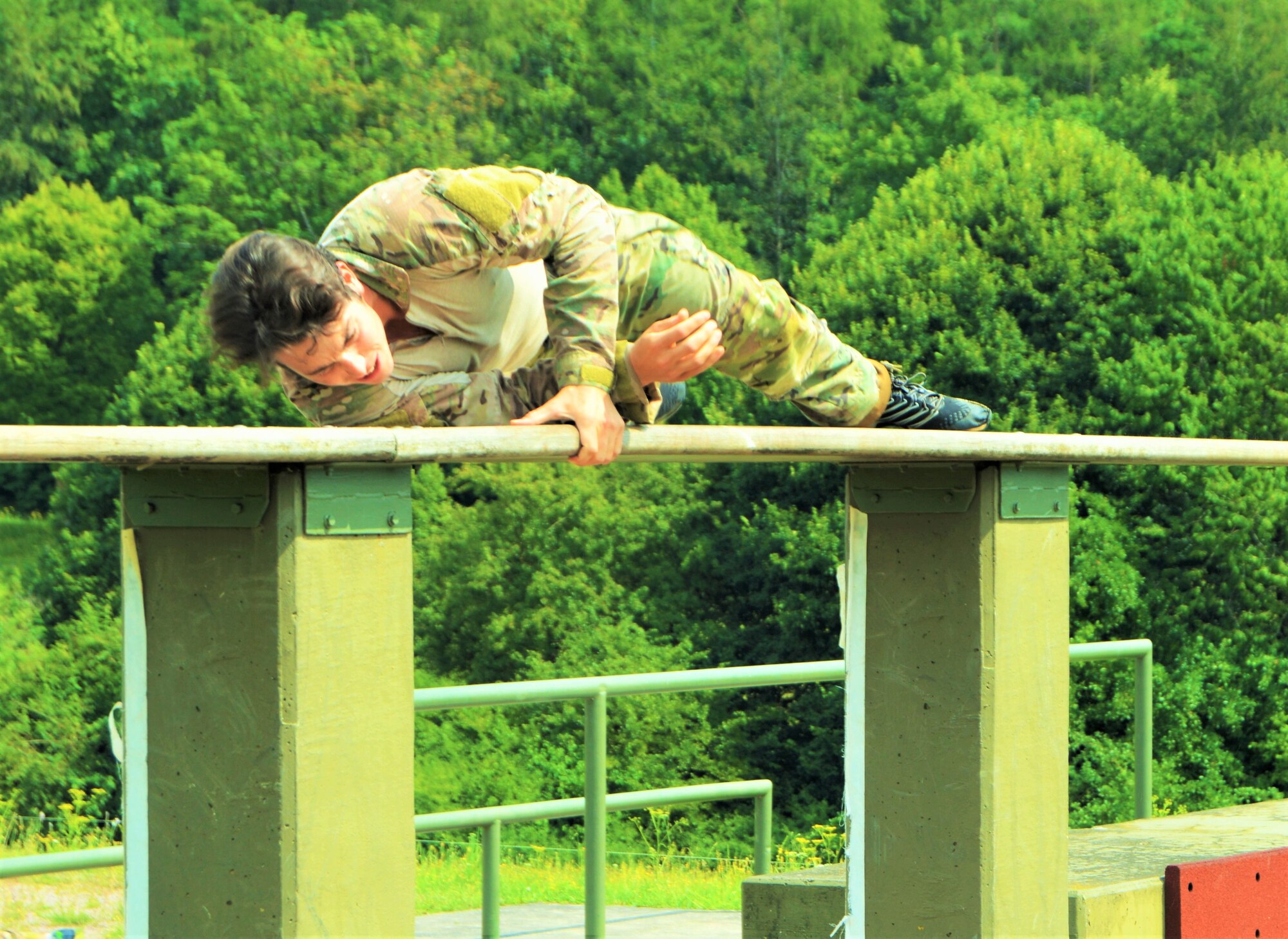 Staff Sgt. Matthew Gaddy, a 306th Rescue Squadron pararescueman, navigates an obstacle course in Frankfurt, Germany, during training camp for an international military competition July 19 to 31. The competition, Held Aug. 1 through 4 in Madrid, Spain, consisted of shooting, land navigation, and multiple obstacle courses. Seventeen international teams competed, and Gaddy's team took third place. (Courtesy photo)